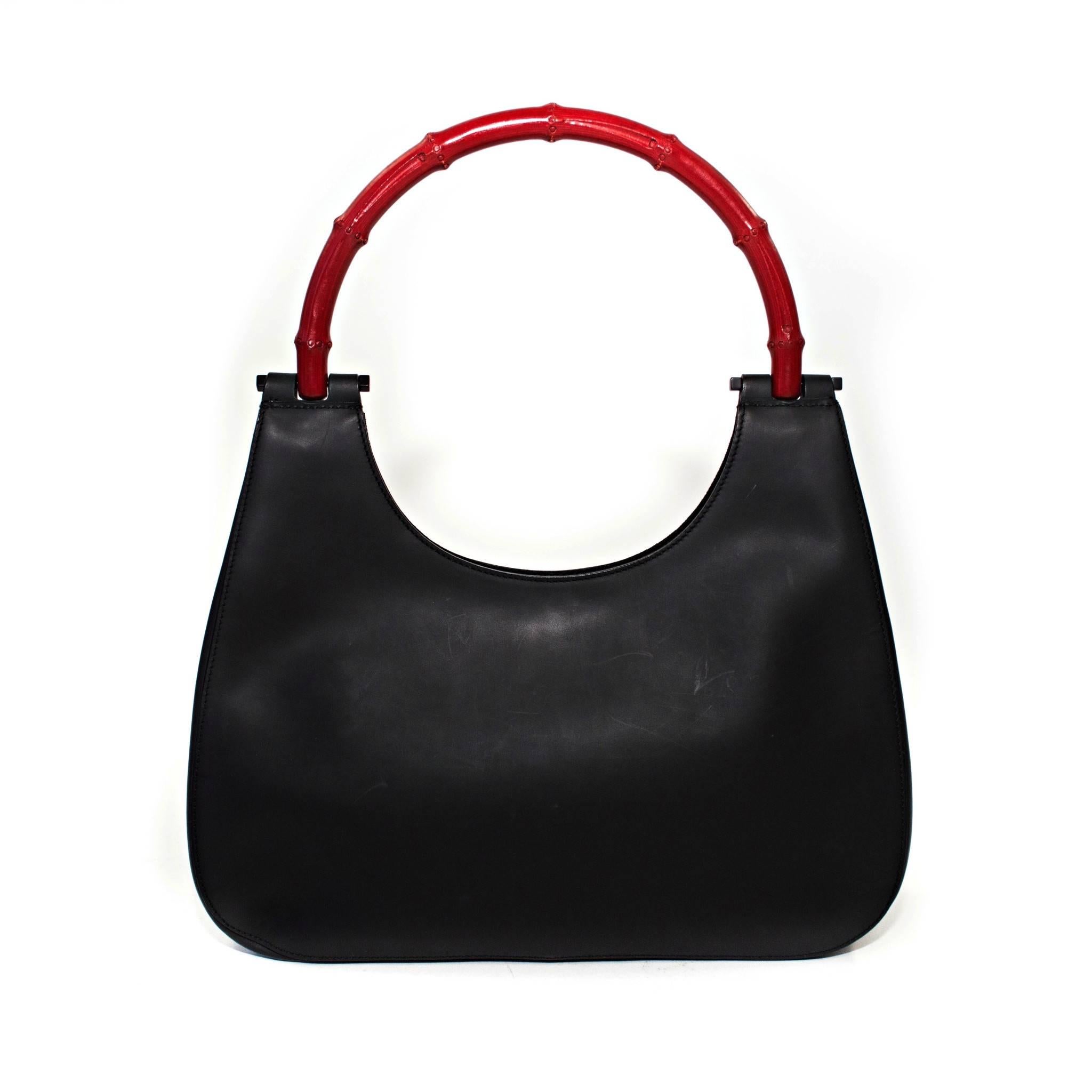 Gucci matte black Hobo style handbag with red bamboo handle.

Good Vintage Condition:Please remember all clothes are previously owned and gently worn unless otherwise noted.