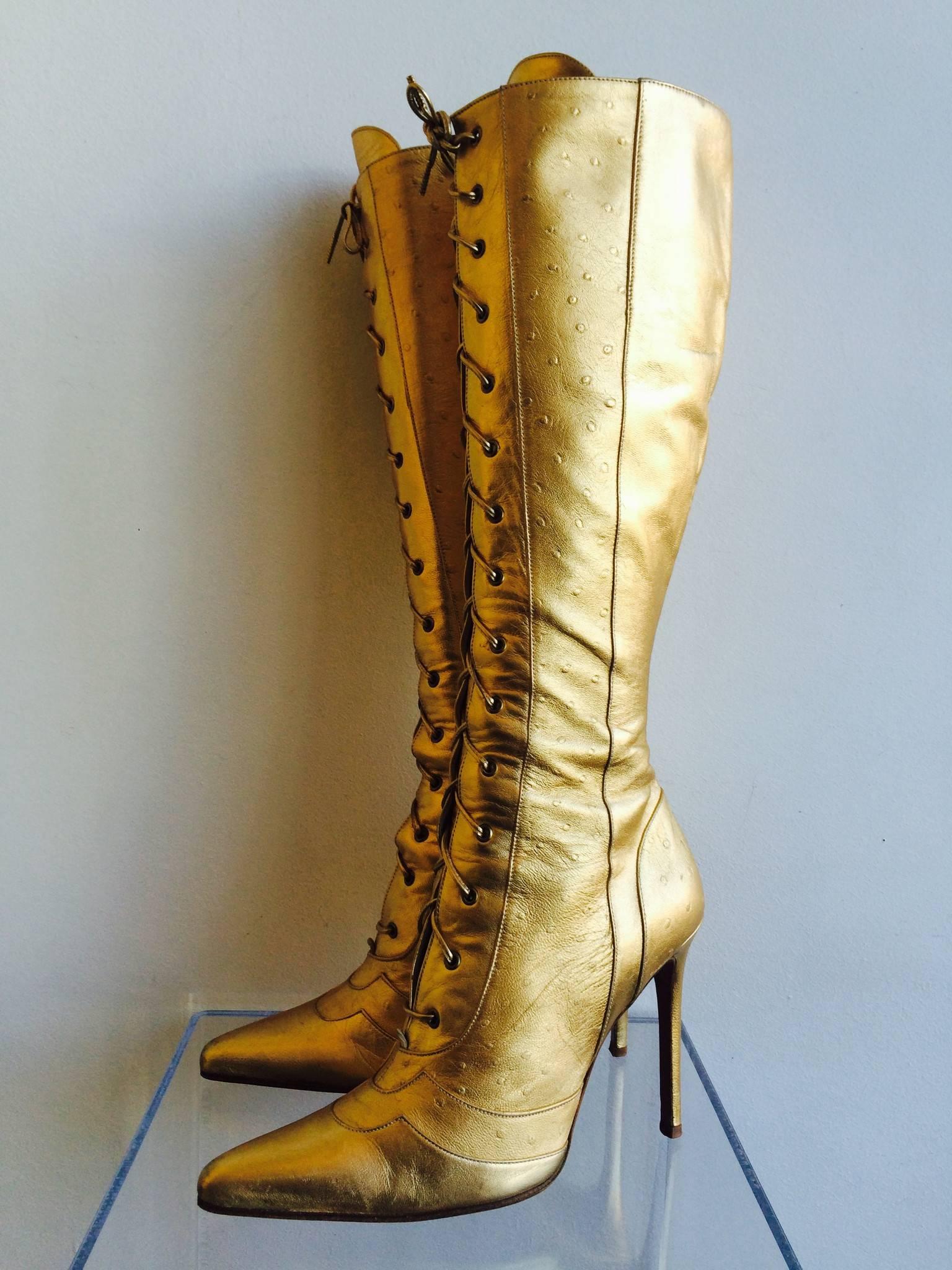 Christian Dior gold ostrich leather lace up boots with pearl colored leather lining. These boots come with a lace up front and side zipper for easy fitting. 

Made in Italy

Size Marked: 7, Heel Height: 4"

Good Vintage Condition:Please