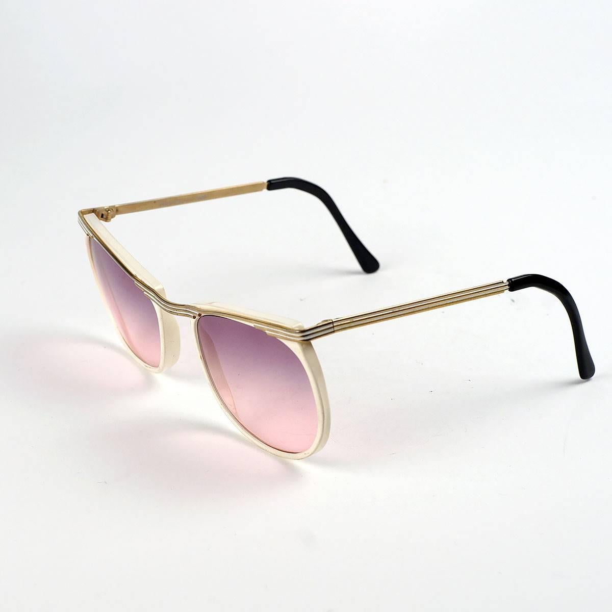 EUROSPORT sunglasses with pink tinted lens and gold accented white frames, part of the Daniel Hunter collection by Rem. 

Made In France. 

-Measurements-
Lens- 1.5 inches high, 2 inches wide 
Arm- 4.5 inches 
Frame- 5 inches 
Bridge- 1/2 inch

Good