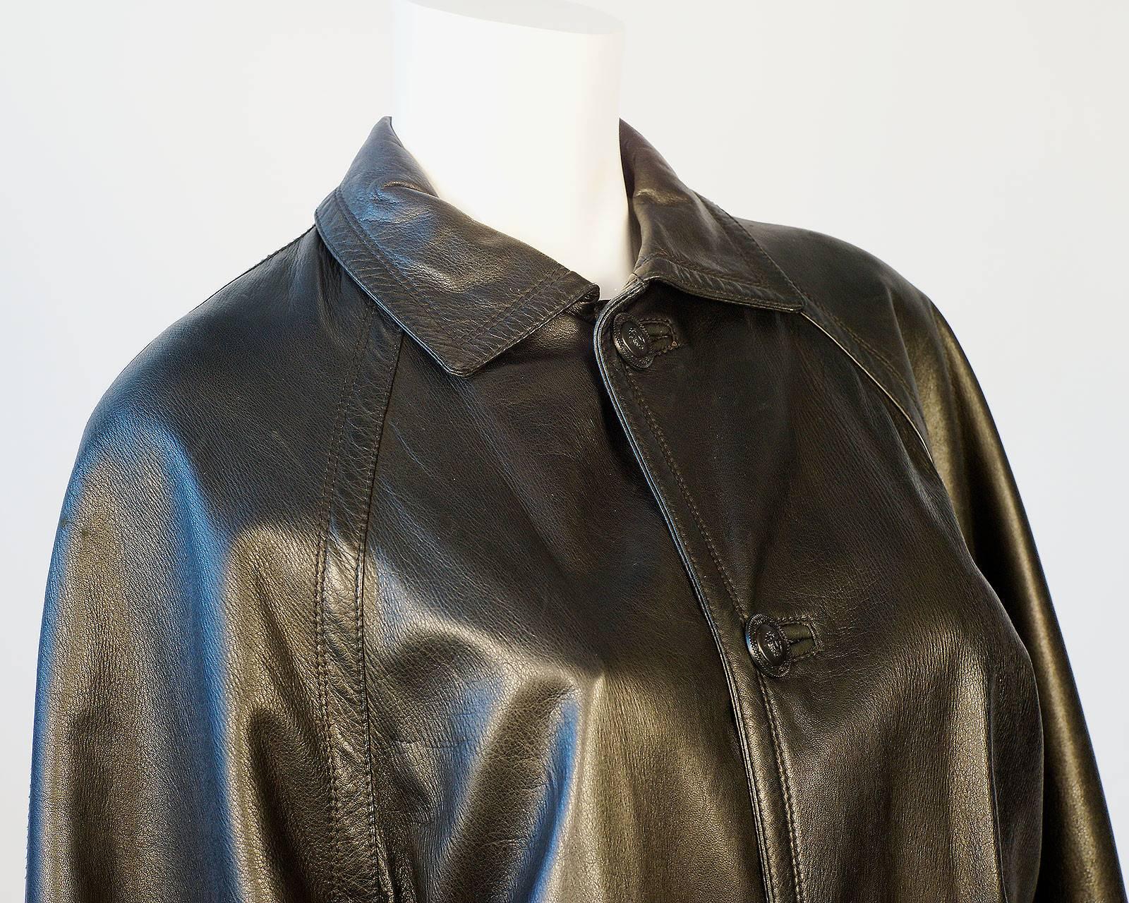 Gianni Versace black leather car coat with cashmere/satin lining and medusa logo buttons.

-Measurements-
Jacket Waist: 23