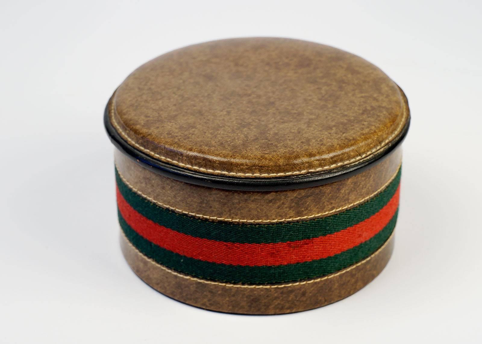 Vintage 1970's Gucci leather Jewelry/Desk box with hallmark red and green woven ribbon pattern and red interior.

-Measurements-
Tall: 3"
Diameter: 5"
 
Good Vintage Condition:Please remember all clothes are previously owned and gently
