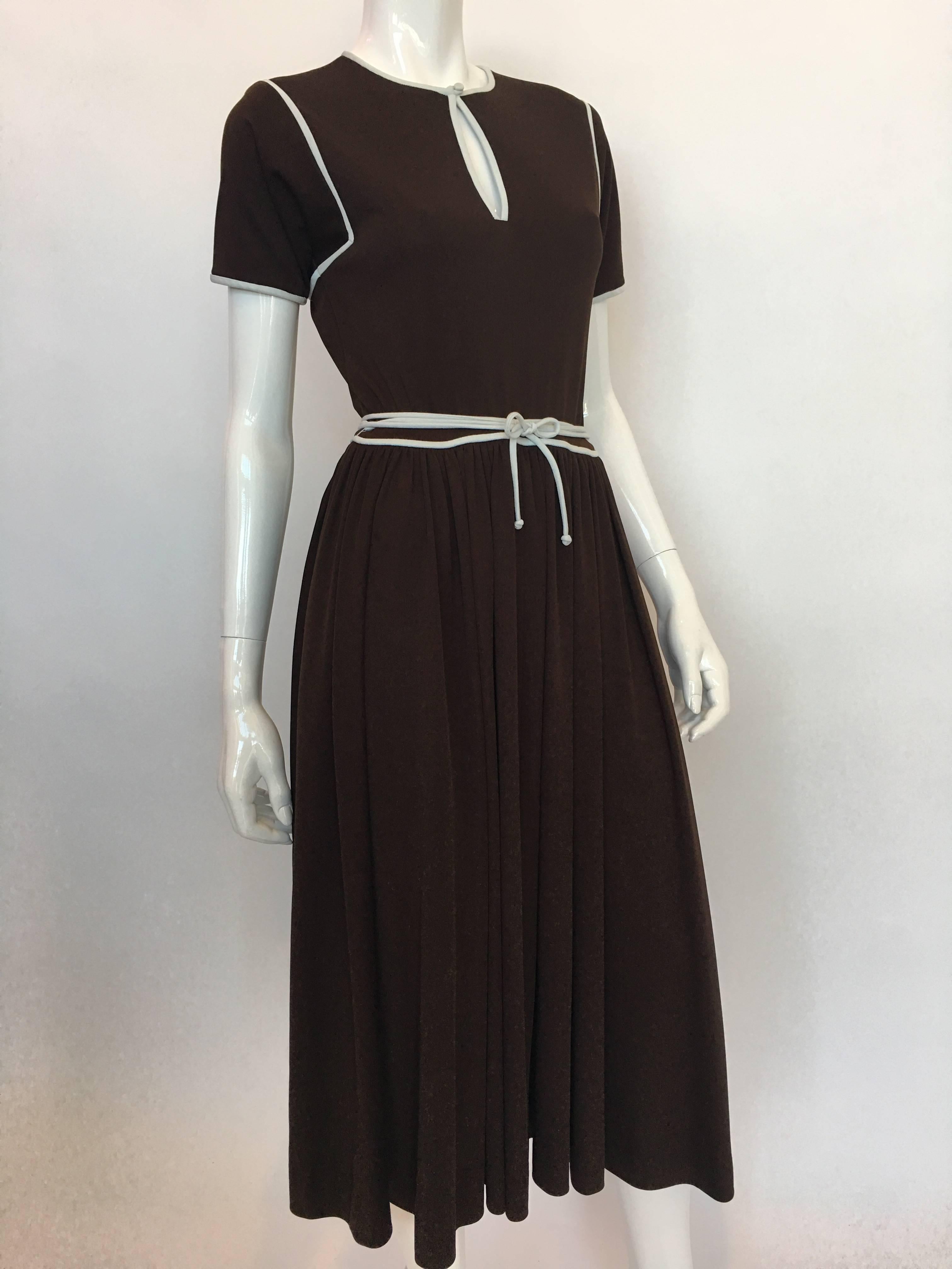 1970s Donald Brooks Brown Poly Dress With White Piping

Measurements taken flat:
Shoulders - seam to seam: 14