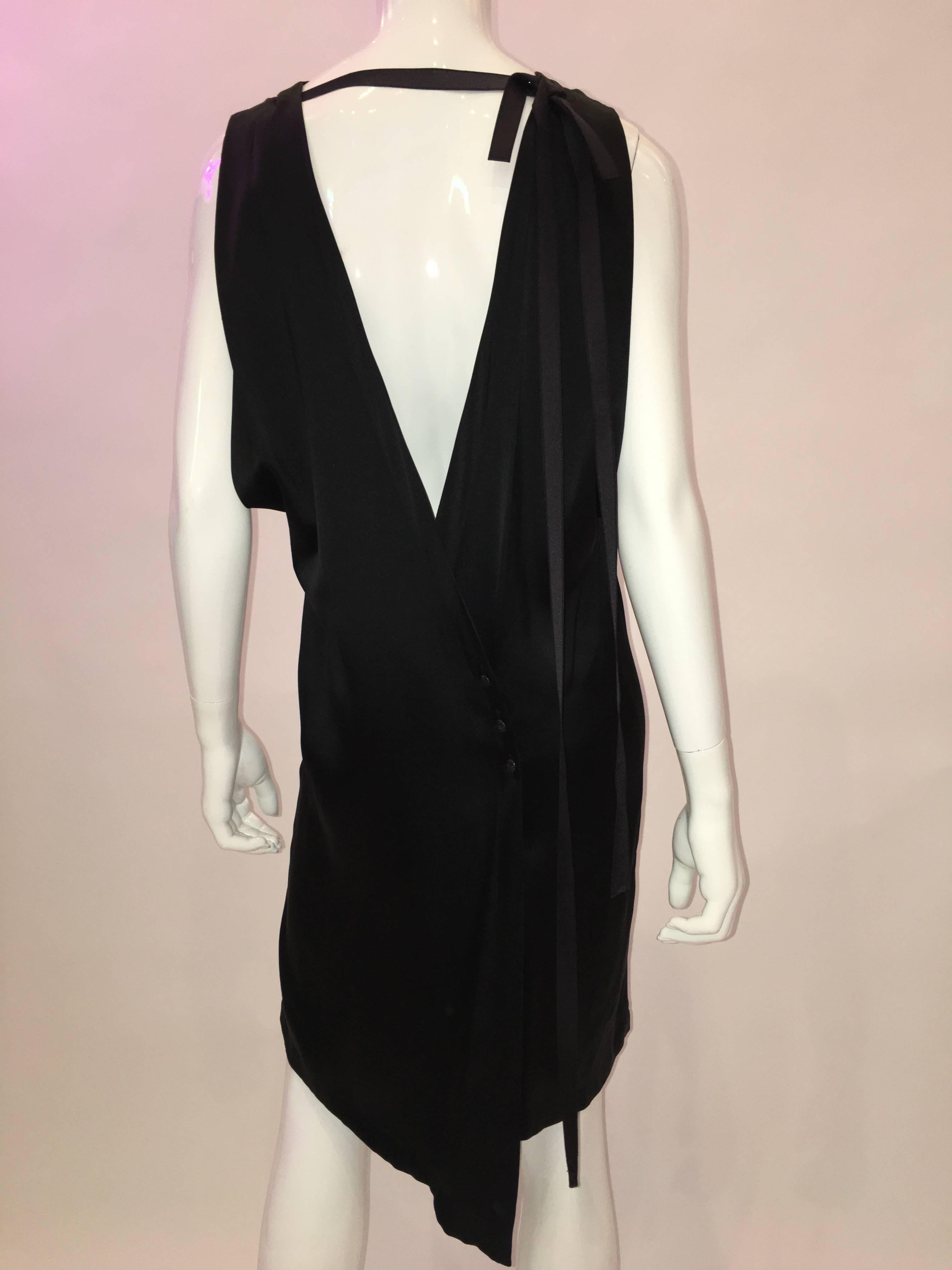 Chanel Black Silk Sheath Dress , straight cut that skims over the hips.
This dress has a satin ribbon attached at the neckline and hidden buttons at the back of the dress closure.

*ALL MEASUREMENTS TAKEN FLAT*
Label Size - 38 
Back V Opening - 14