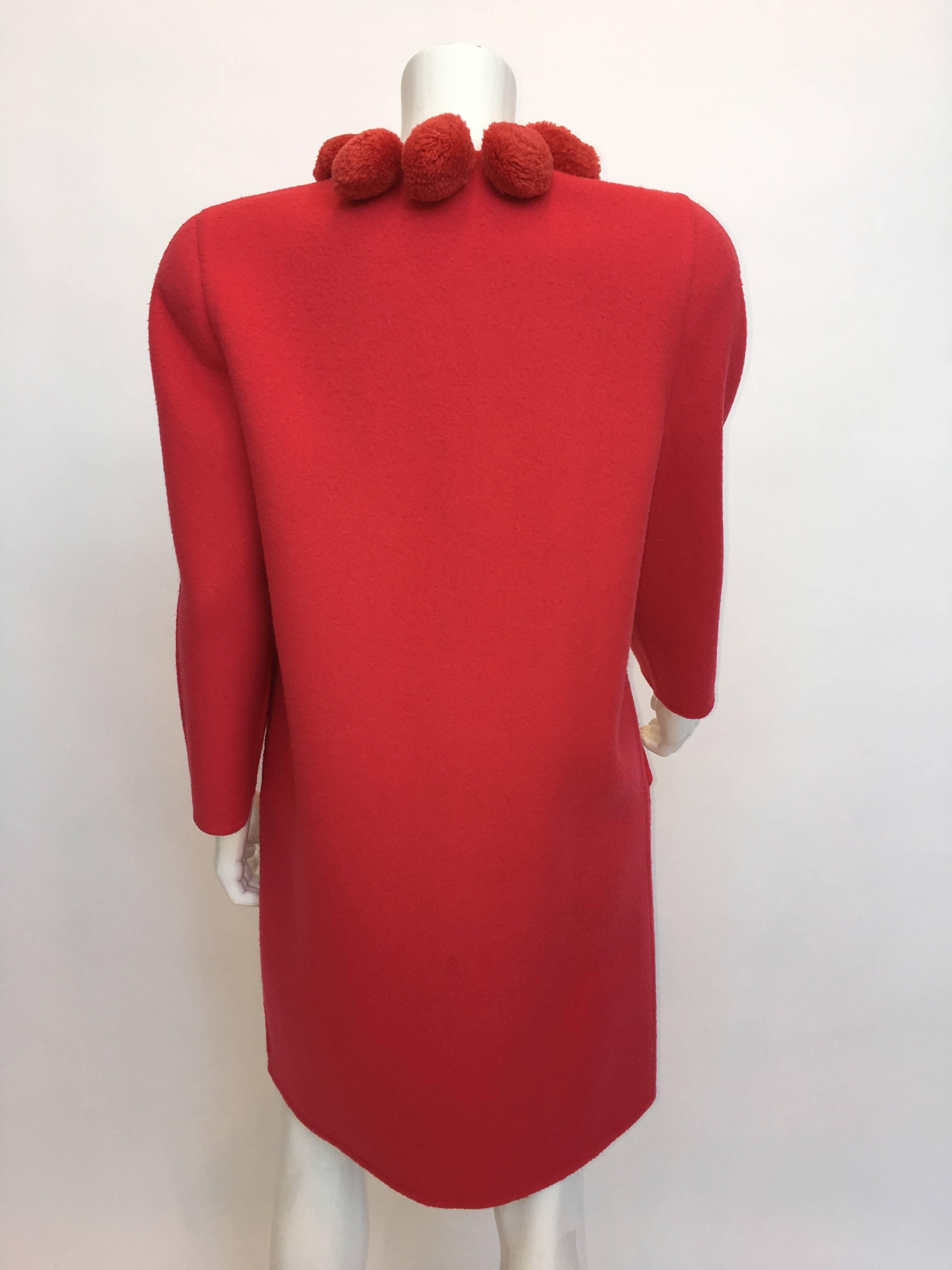 Bill Blass 1980's Pink Coral 100% Wool Coat with Pom Poms. Coat has shoulder pads, 2 front side pockets and snap closures.

*ALL MEASUREMENTS TAKEN FLAT*
Size Label: 6

Shoulder to shoulder: 16