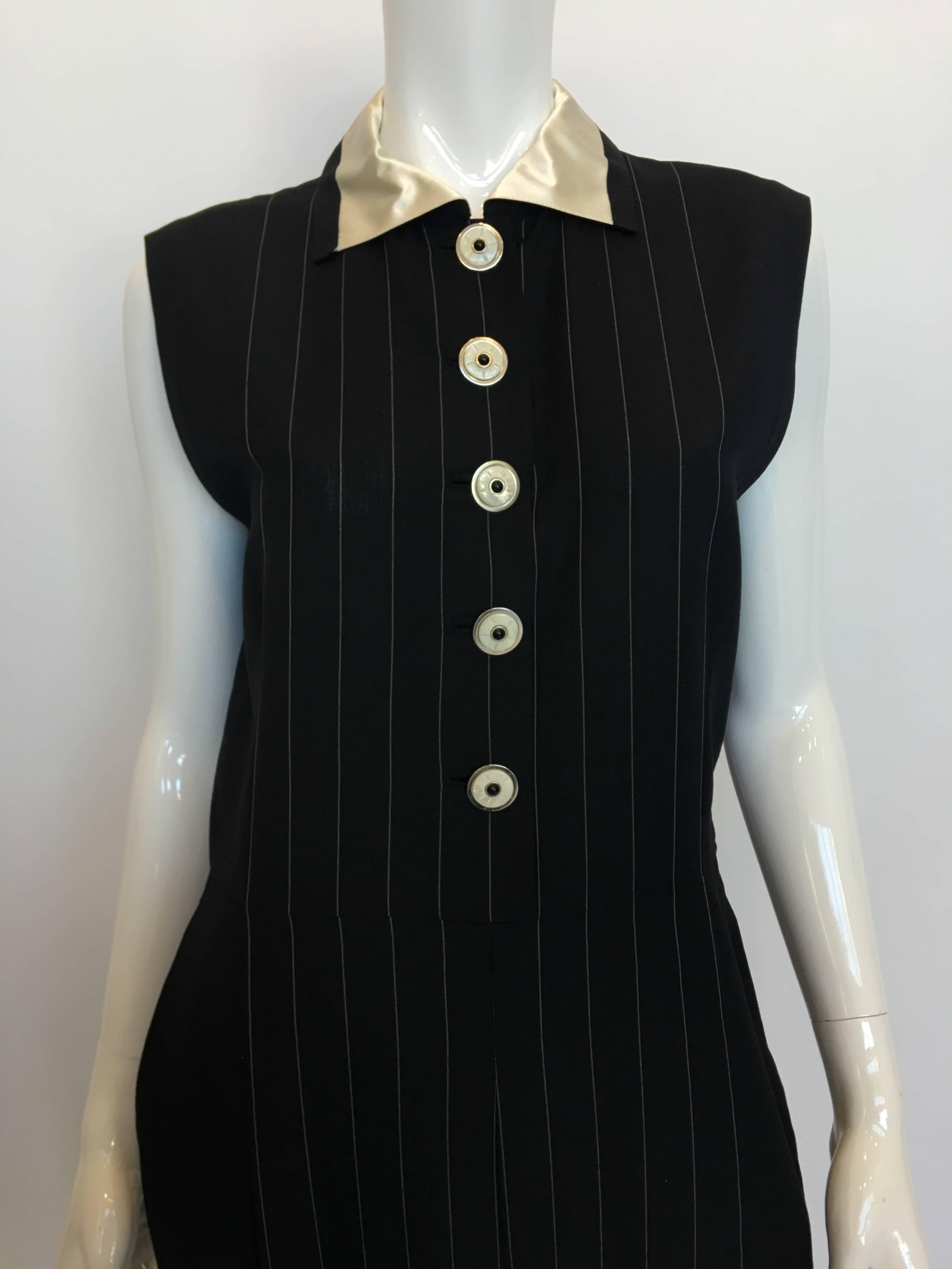 Gianni Versace Couture 1980's Black Pin Striped Jumpsuit. Light weight wool , inset button holes with shell buttons. Has a satin collar with trouser pockets.

*ALL MEASUREMENTS TAKEN FLAT*
Size Label: 44

Shoulders (edge of shoulder to edge of