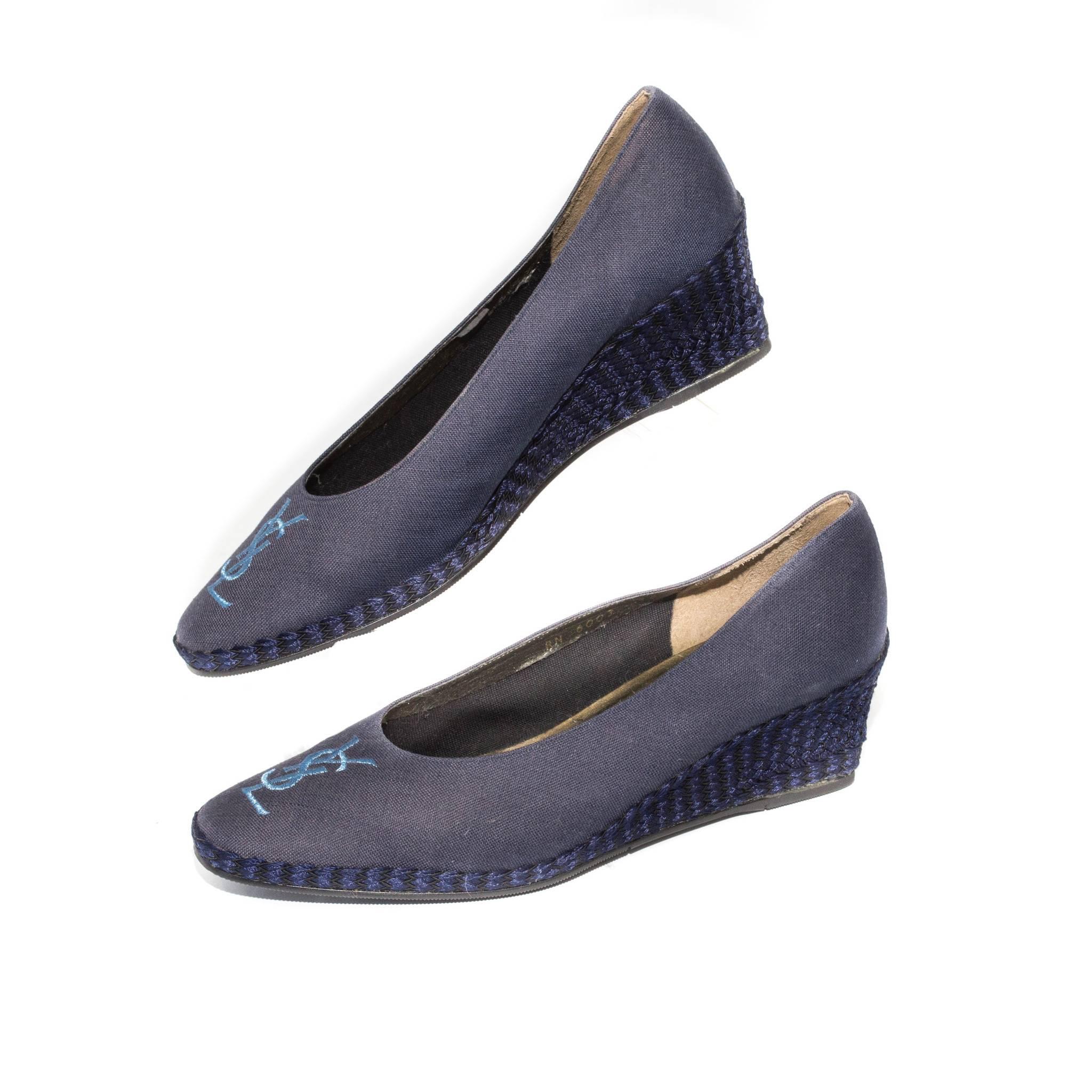 Yves Saint Laurent Blue Espadrilles with YSL Logo Detail.

Size Marked: 6.5

Good Vintage Condition:Please remember all clothes are previously owned and gently worn. These shoes shows color slightly faded.