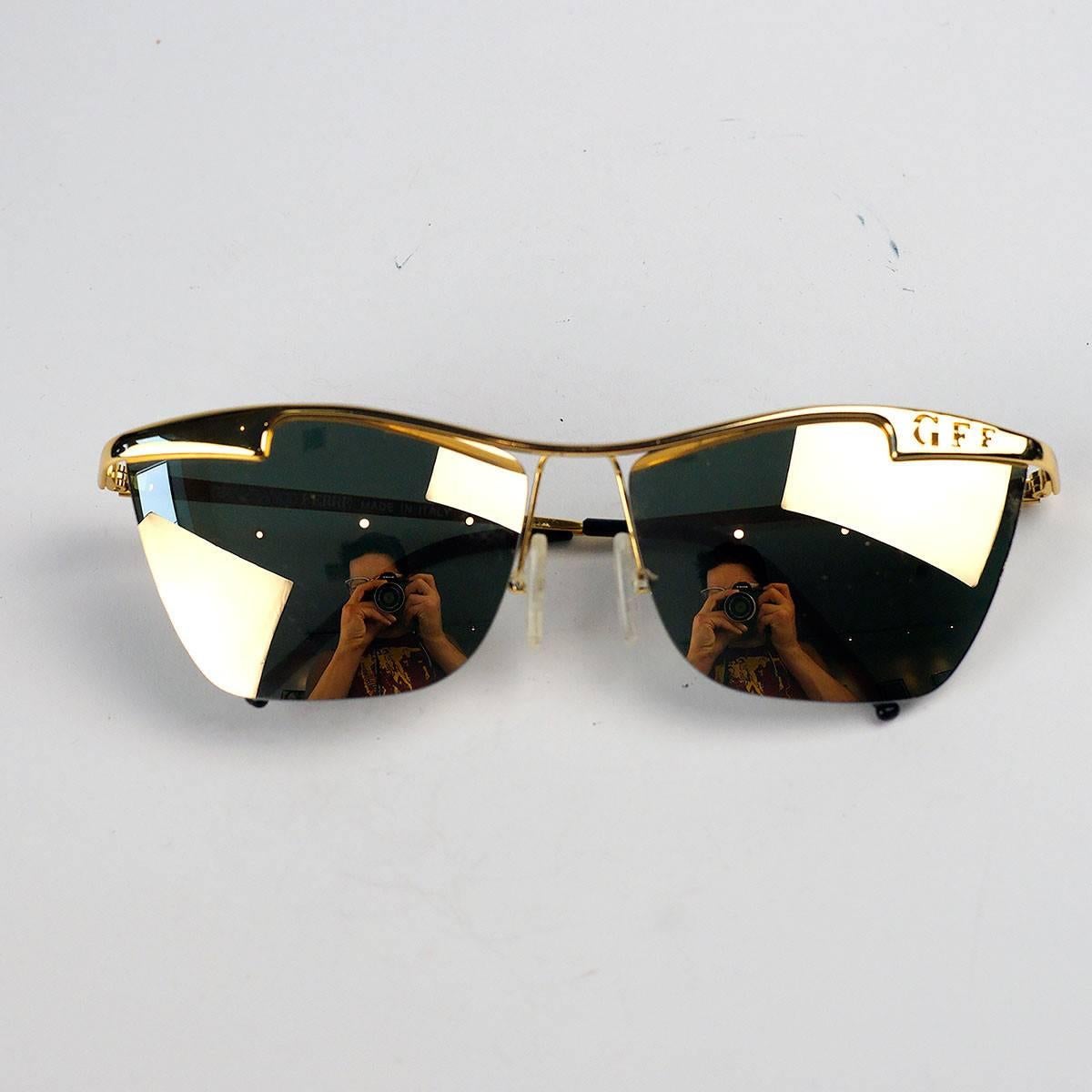 Gianfranco Ferre gold mirror cat eye sunglasses. 

Made In Italy. GFF 56/S 001

Measurements:
Lens-2 inches wide, 1.5 inches high
Arm- 4.5 inches 
Frame- 5 inches 
Bridge- 4 cm

Good Vintage Condition:Please remember all clothes are previously owned