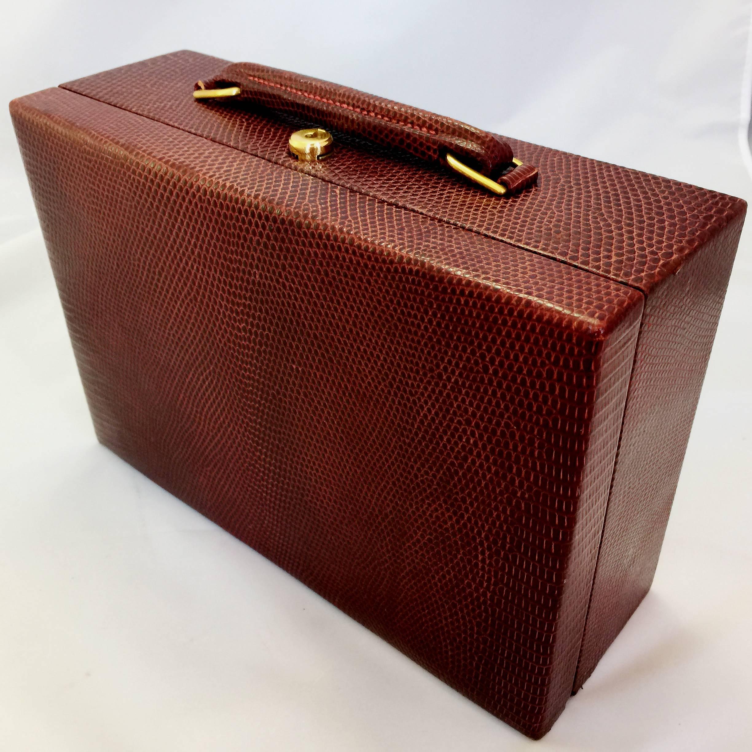 Hermes red lizard skin jewelry box with red velvet lining, brass hardware and 2 original brass keys. Inside is a removable tray with 6 compartments and a large open storage area underneath.

Circa 1950
Signed "Hermes,