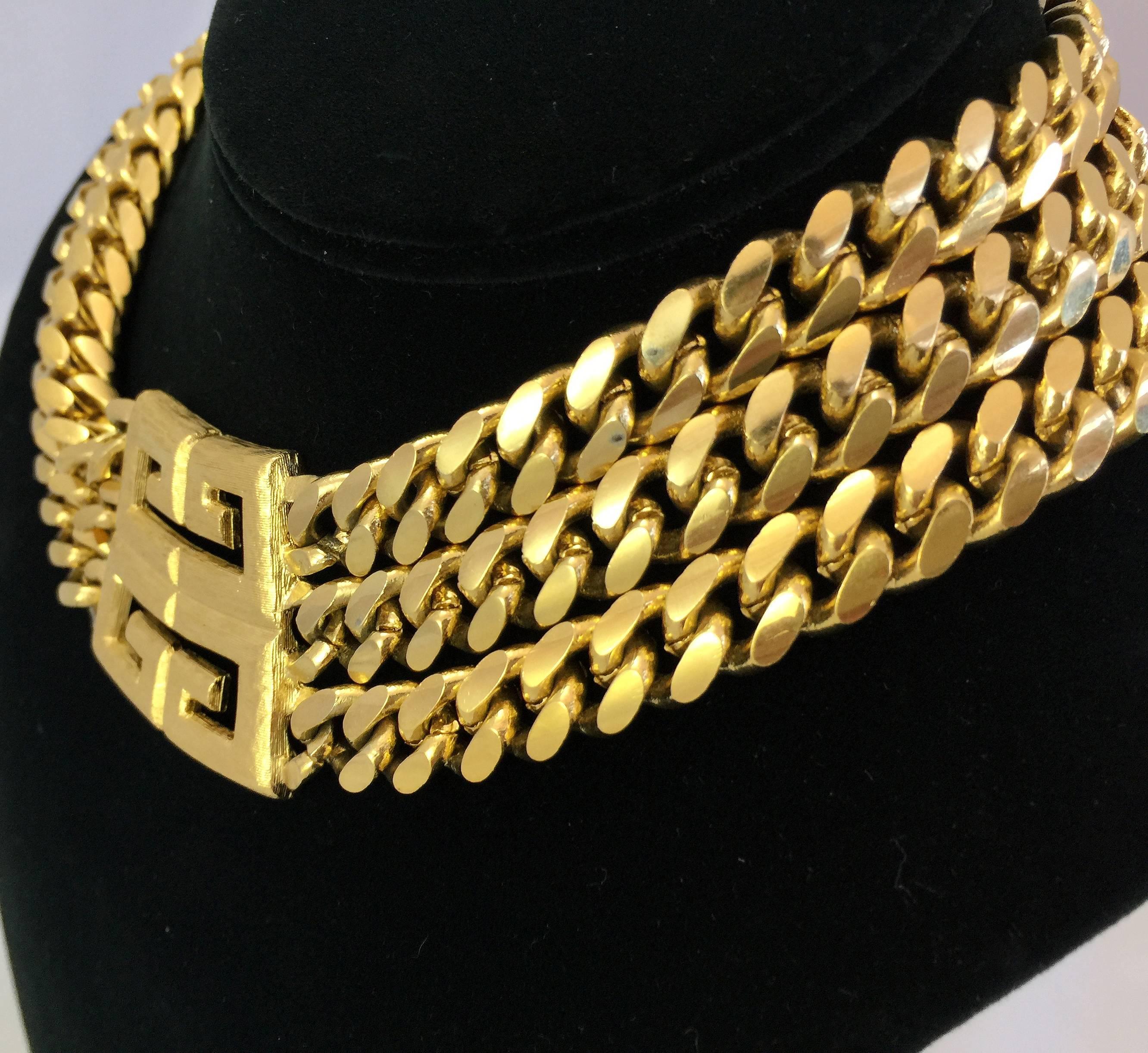 Givenchy Triple chain gold tone necklace with center double stacked double G Givenchy Monogram pendant and adjustable back fastener.

Signed: "Givenchy"

Measurements: 
18 inches long & 2.5 inches wide 

Good Vintage Condition: Please