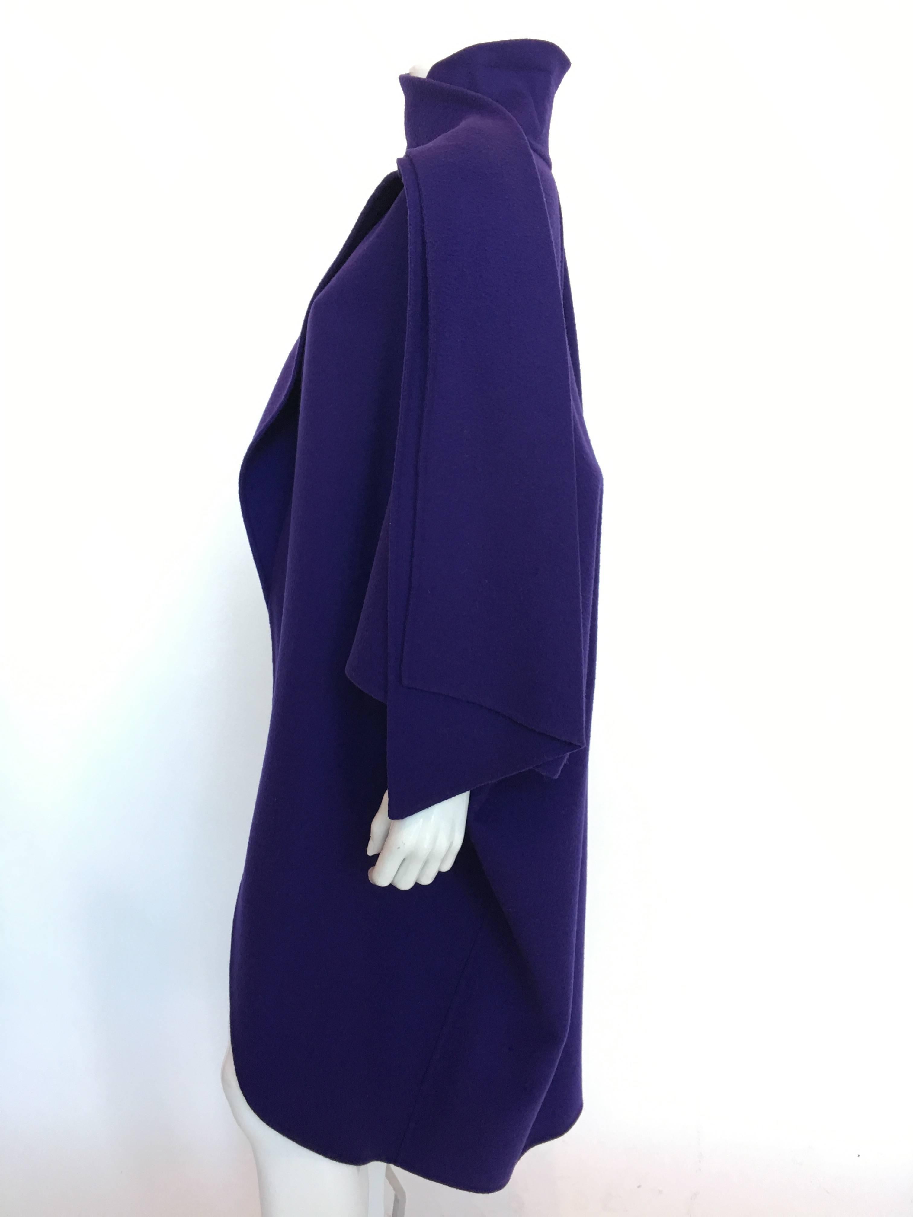 Ferragamo Purple Wool Cape Style Coat with a wrap tie at neck.
Circa 1980's 
I Magnin Department Store
Two tiny holes near left arm opening  (see picture)

*MEASUREMENTS* 
Size tag - Medium
Length (from back collar seam to bottom) - 44