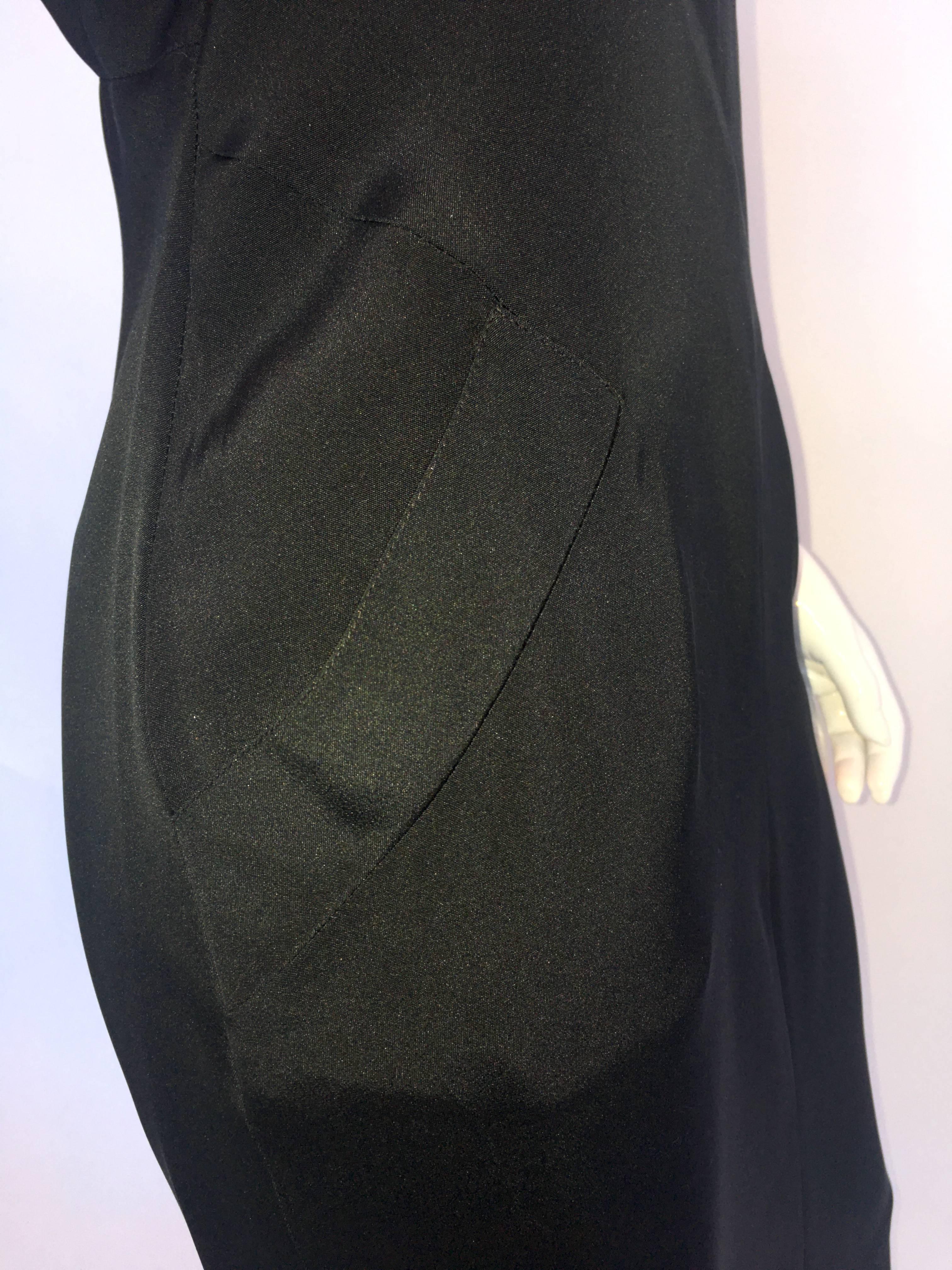 Karl Lagerfeld Black Halter High Neck Dress with two front pockets 
Skirt has back slit.

Size Label - 40 
Neck opening - Circumference 13 1/2 in.

Measured Flat:
Bust - 15 in.
Front Neck to bottom hem - 40 in. 
Hips - 18 1/2 in.
Back slit - 7 1/2