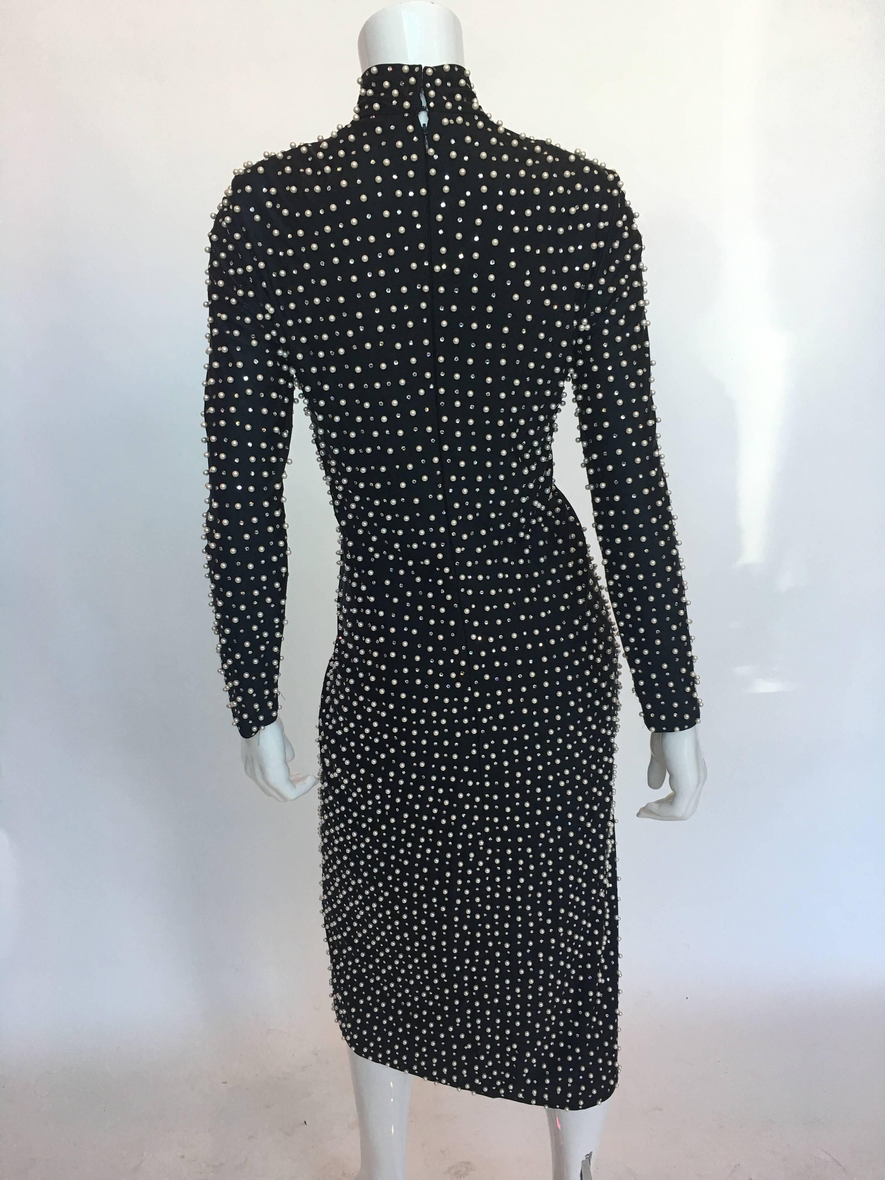 Lillie Rubin pearl and rhinestone encrusted black dress 

Measurements (laid flat):
Shoulder to shoulder seam - 14 1/2 in.
Shoulder seam to wrist cuff - 22 1/2 in.
Armpit to armpit - 15 in.
Waist - 13 1/2 in.
Bust - 15 in.
Hips - 17 in.
Length; neck