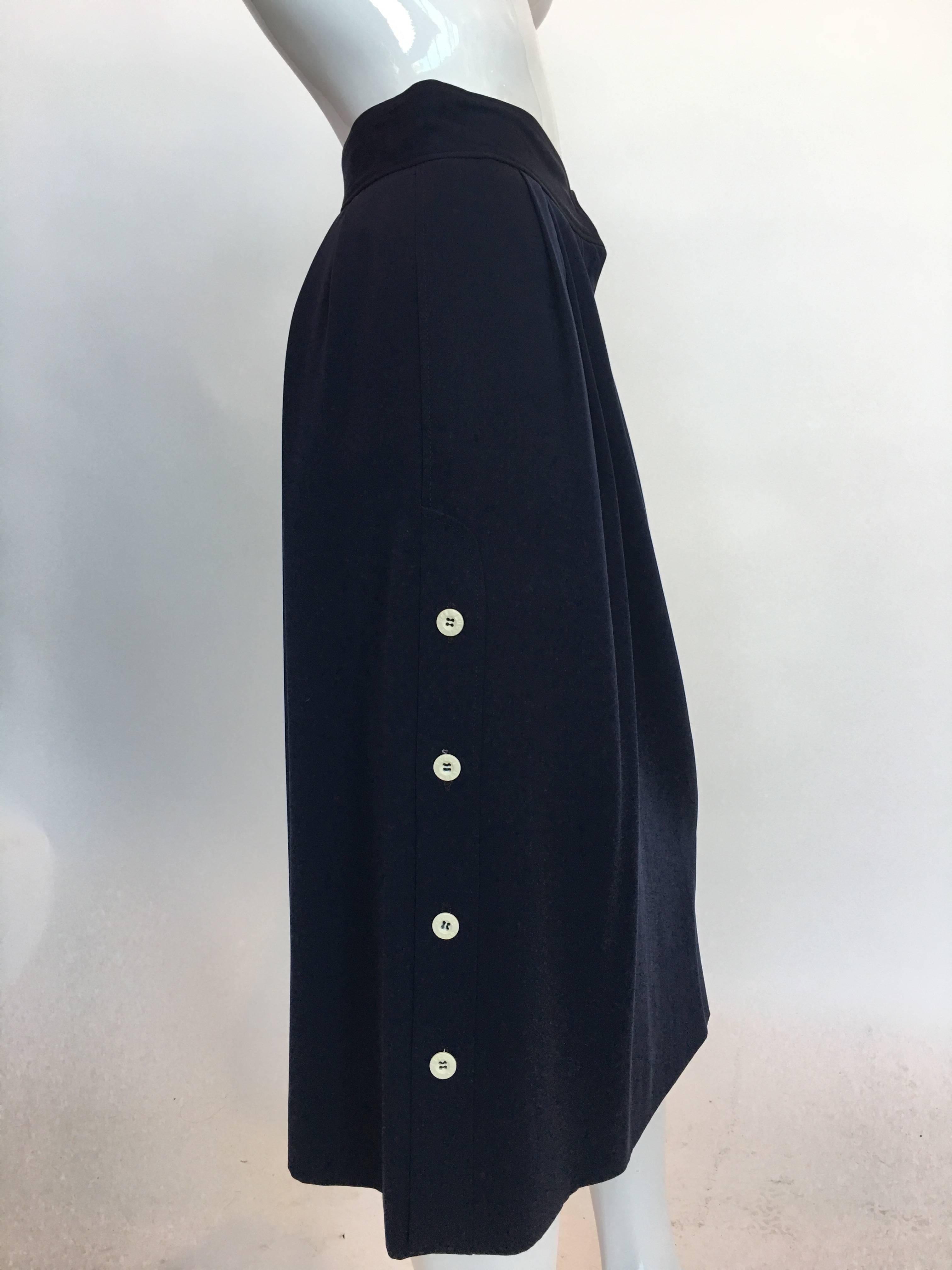 Gucci 1970's Navy Wool Pleated Skirt with buttons up sides.

Waist: 13.5"
Length:
From V front - 28"
Back -  29.5"

Good Vintage Condition:Please remember all clothes are previously owned and gently worn unless otherwise noted.  ALL