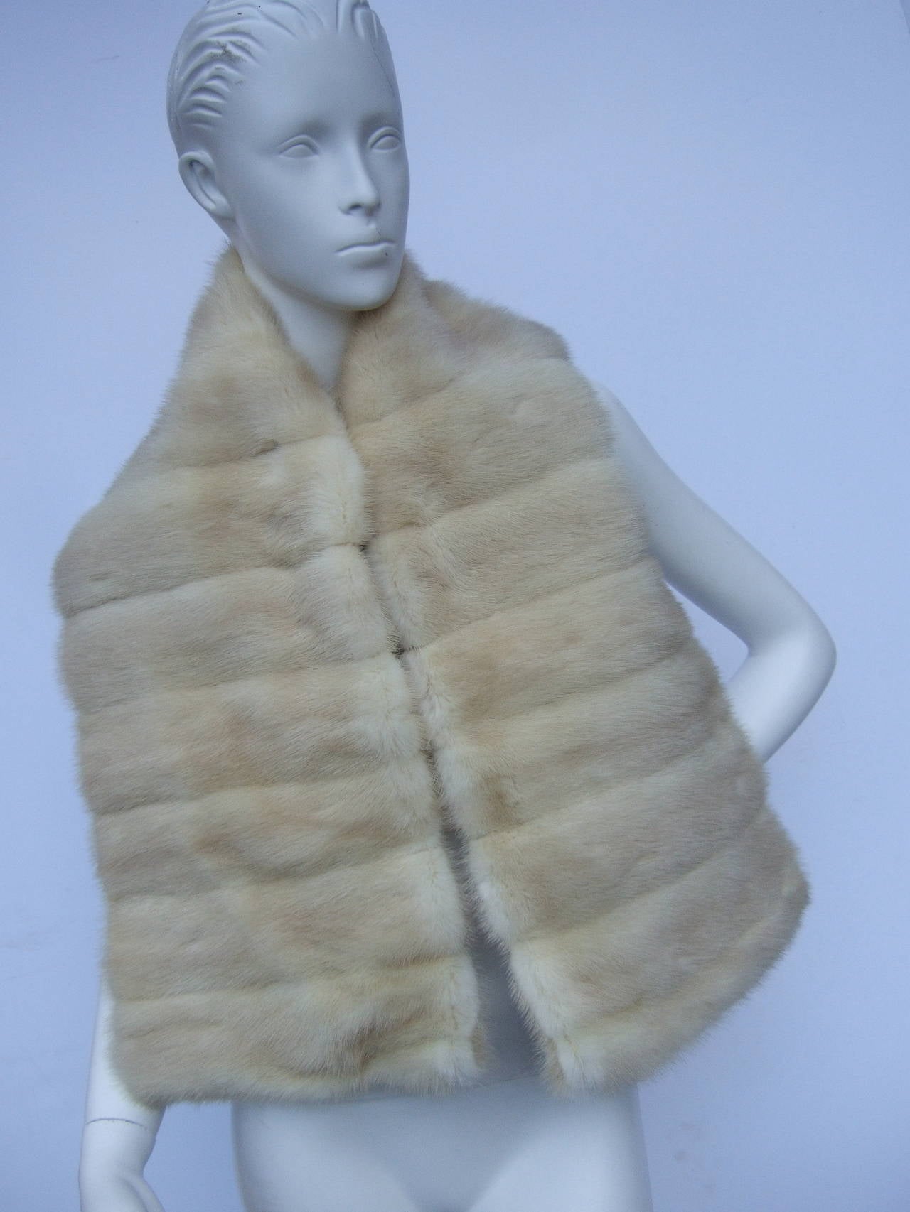 Luxurious oblong blonde mink wrap c 1960
The elegant mink is designed with bands of silky blond mink fur
The fur stole makes a very chic accessory wrapped around the
shoulders

The fur also makes a lavish accessory draped over a bench 
The