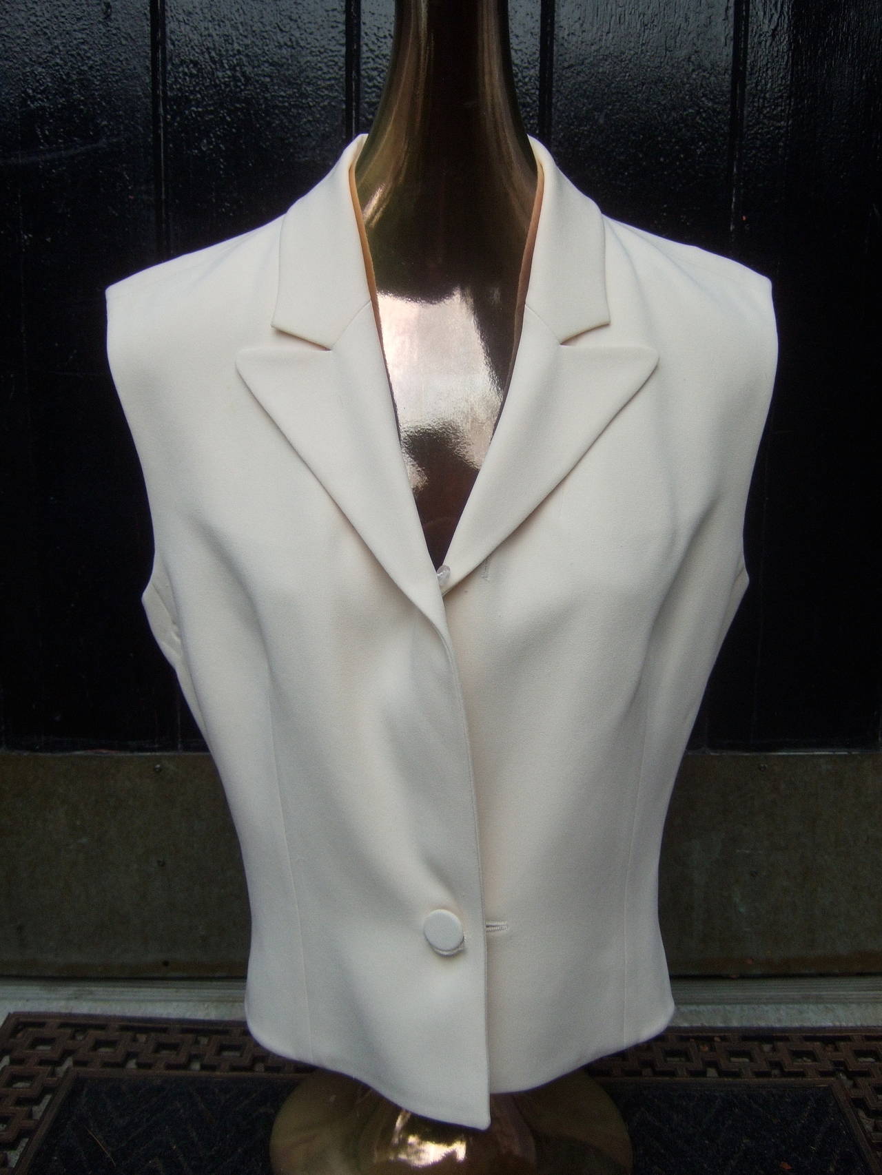Hermes Paris ivory silk blouse vest  Made in France Size 38
The luxurious blouse is designed with double faced silk
The elegant blouse / vest secures with a single matching cloth 
covered button

The stylish silk blouse may be worn individually