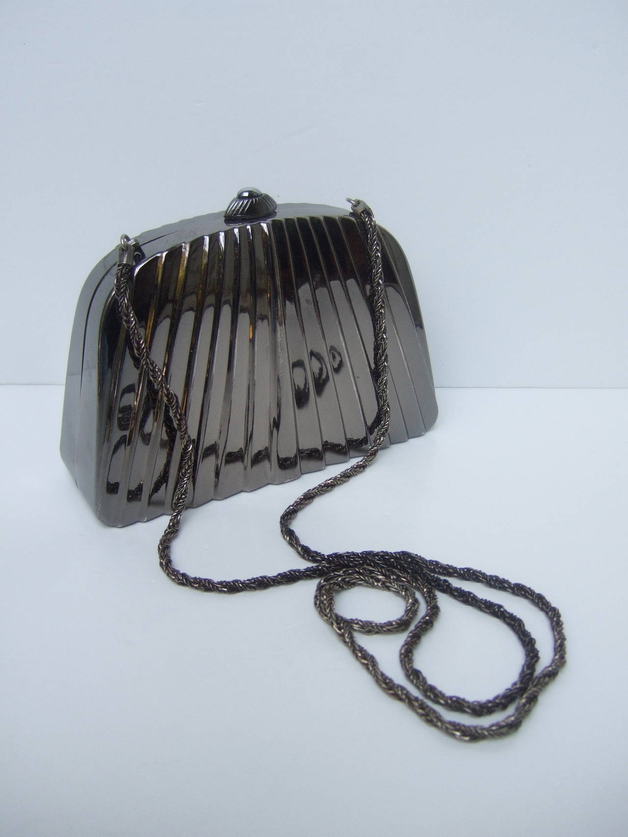 ***RESERVED SALE PENDING FOR SANDRA MITCHELL***

Neiman Marcus Sleek pewter metal evening bag Made in Italy c 1980s
The elegant evening bag is designed with a darkened pewter tone metal finish. The exterior panels are designed with linear