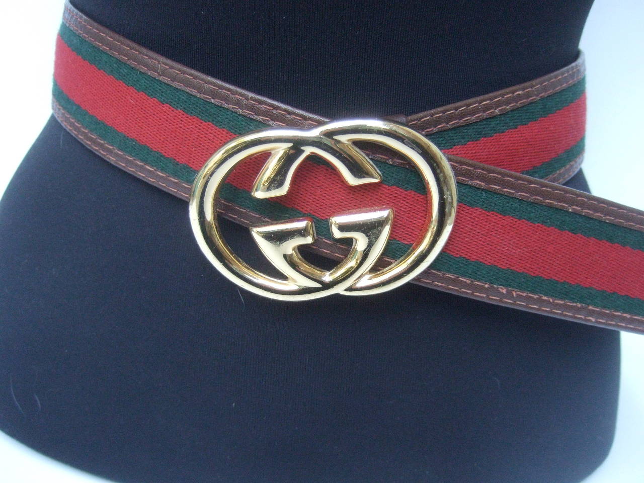 Gucci sleek gilt buckle red & green striped webbed belt c 1980s
The stylish designer belt is adorned with Gucci's massive gilt metal interlocked initials. The wide Italian unisex belt has Gucci's signature red & green webbed stripe. The belt is