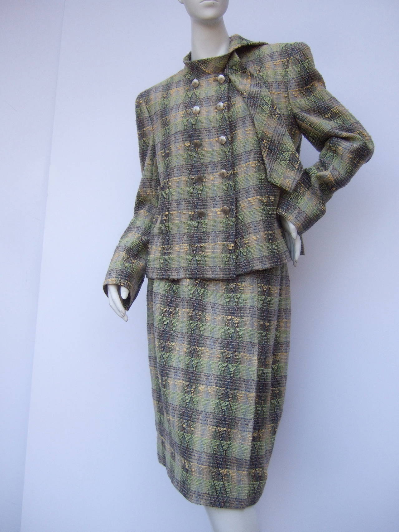 Chanel Boutique Elegant wool & silk knit skirt suit Size 44
The chic skirt suit is designed with chunky wool & silk blend fabric in pale green, grey & yellow hues. The stylish jacket is designed with sixteen Chanel silver metal logo buttons. The