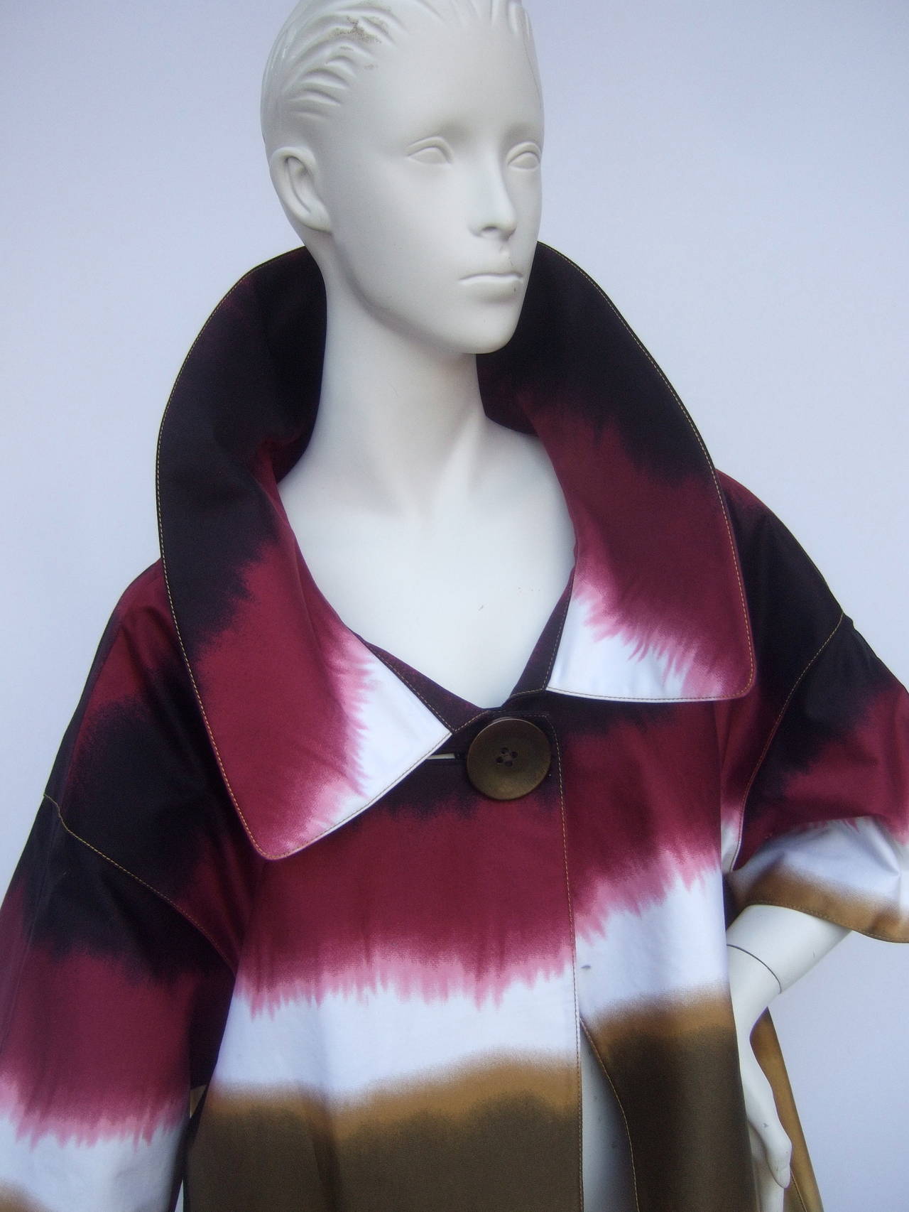 Mod cotton print tie dyed duster coat designed by Ellen Tracy Size Large
The unique high fashion cotton 3/4 length coat has a color blocked tie dye design combined with berry & white that transitions into earth tone colors
The coat is designed