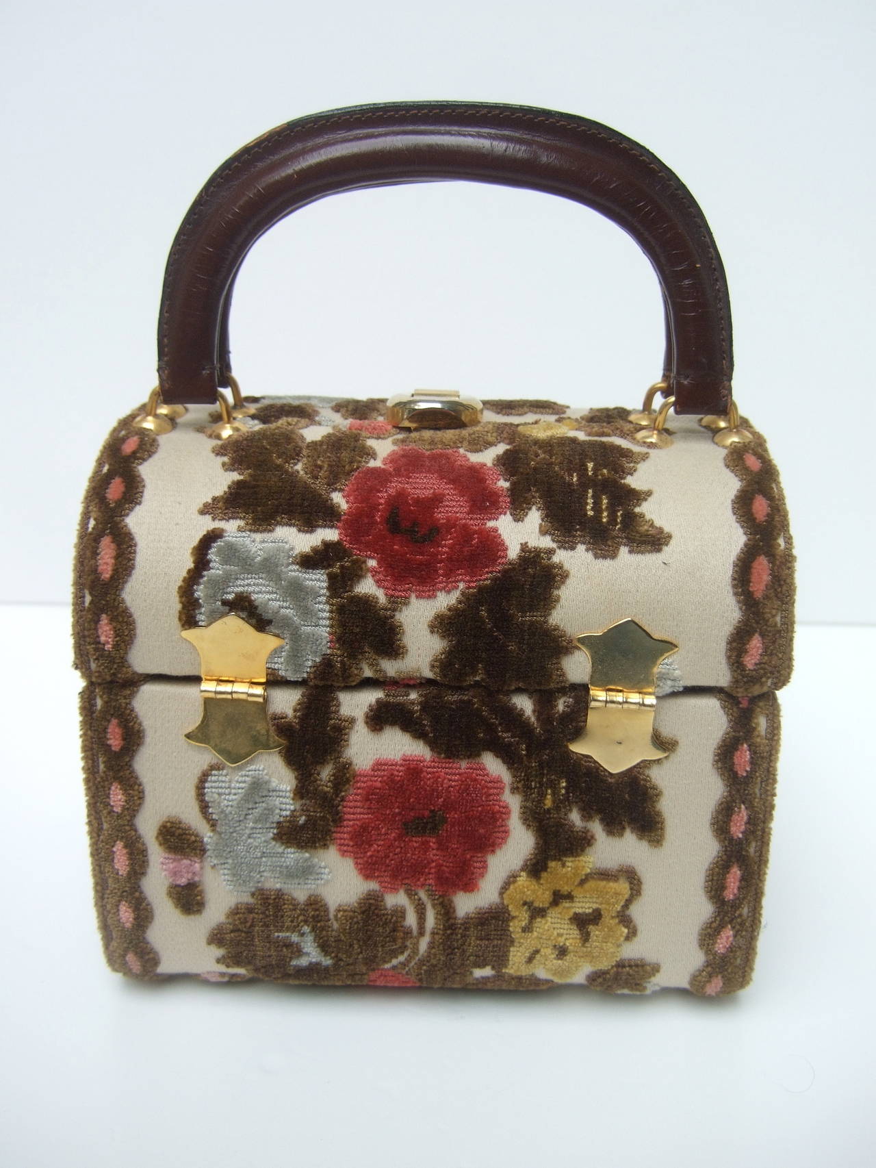 Brocade box style handbag designed by Tano of Madrid c 1970
The posh retro handbag is covered with cut velvet brocade designed with roses & leaves. The burgundy & pale blue roses are surrounded by moss green cut velvet leaves

The twin handles &