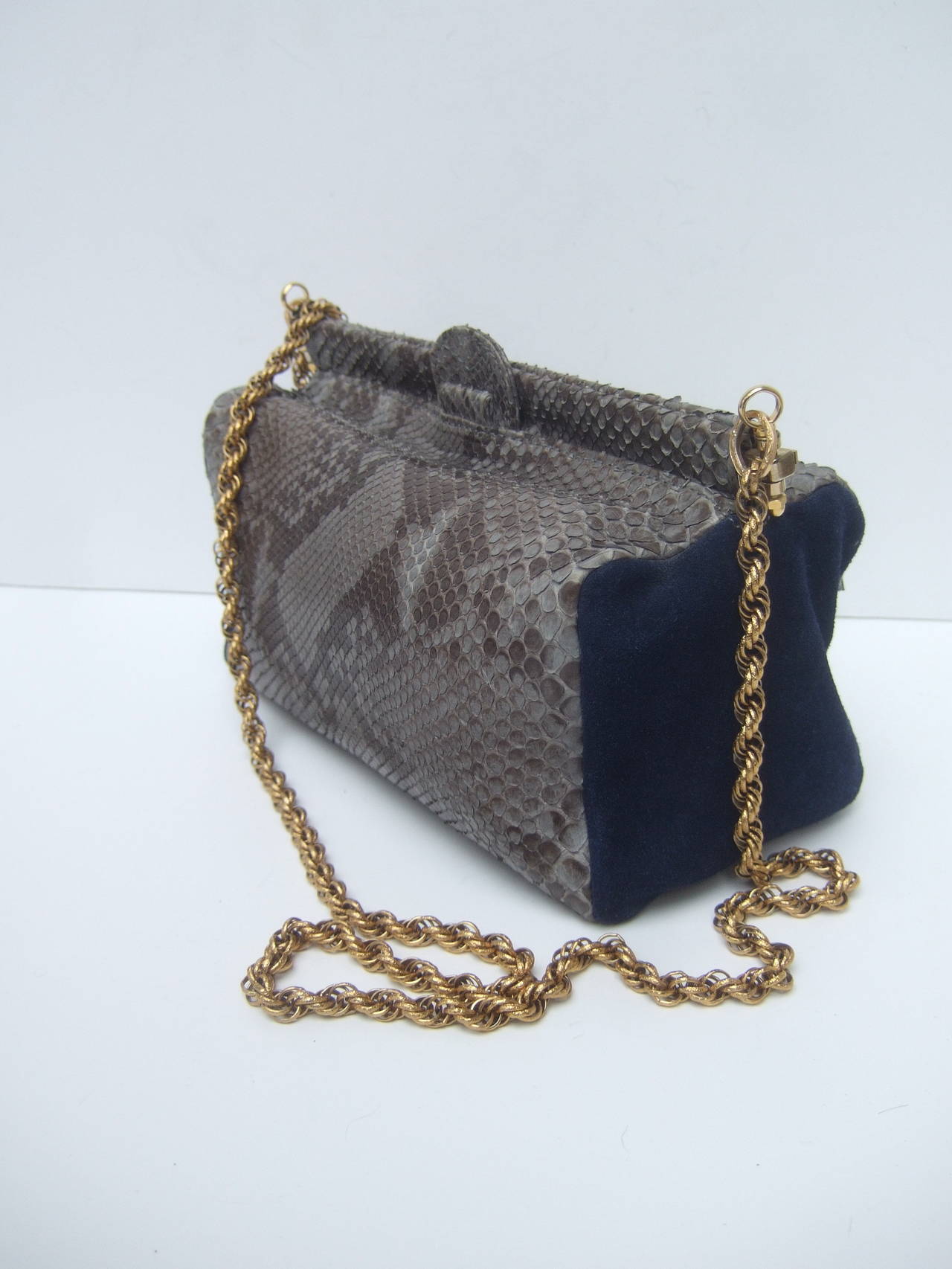 Exotic python & suede handbag designed by Meredith Wendell Italy 
The unique shoulder bag is covered with two tone gray python skin with plush blue suede side panels

The Italian shoulder bag is designed in a boxy shape & hangs from a gilt metal
