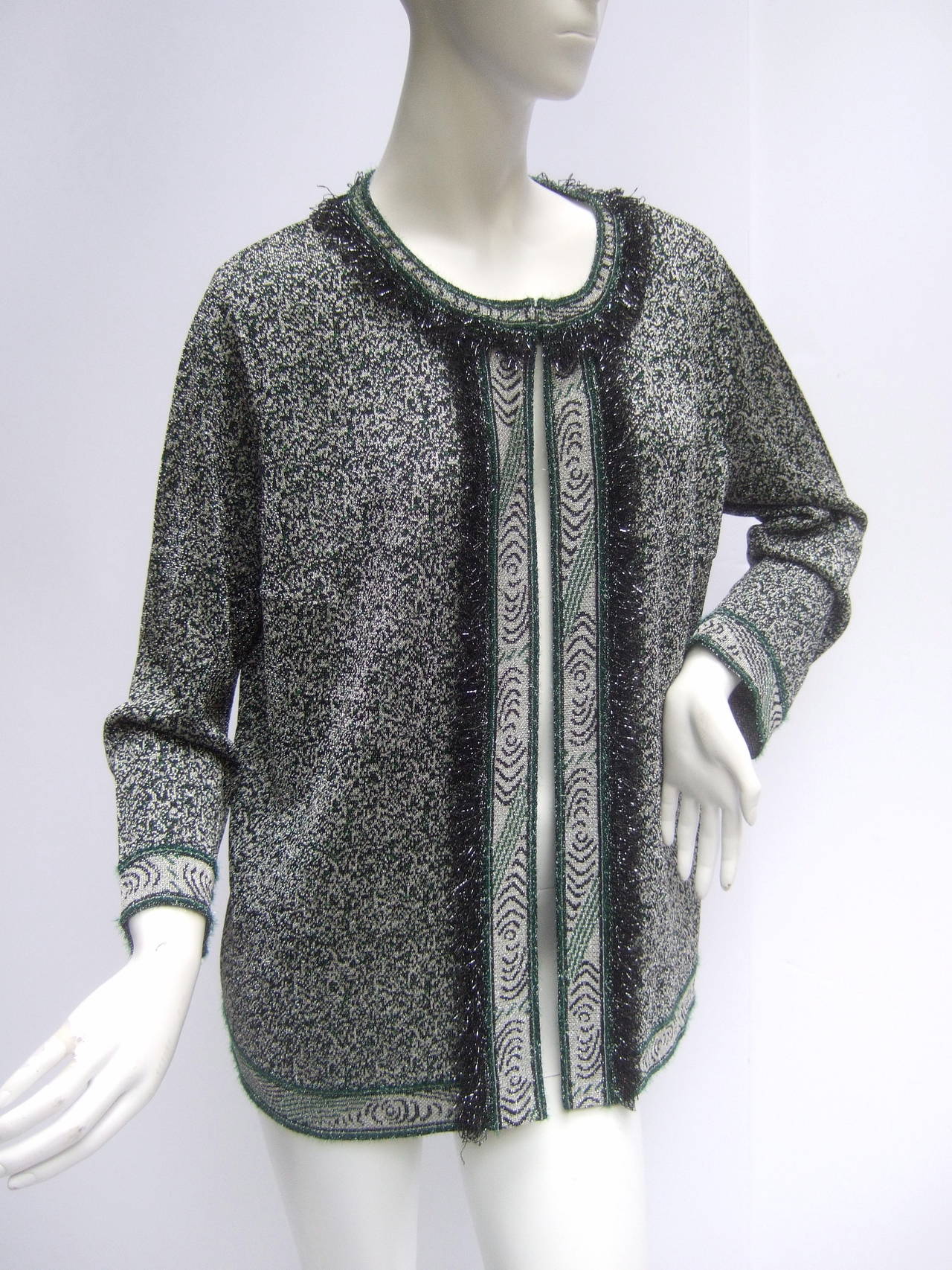 Missoni Italy silver metallic knit cardigan US Size 12
The stylish Italian knit cardigan is designed with silver metallic, gray, black & green colors. The collar, cuffs, front opening & hemline are accented with a metallic fringe border

The