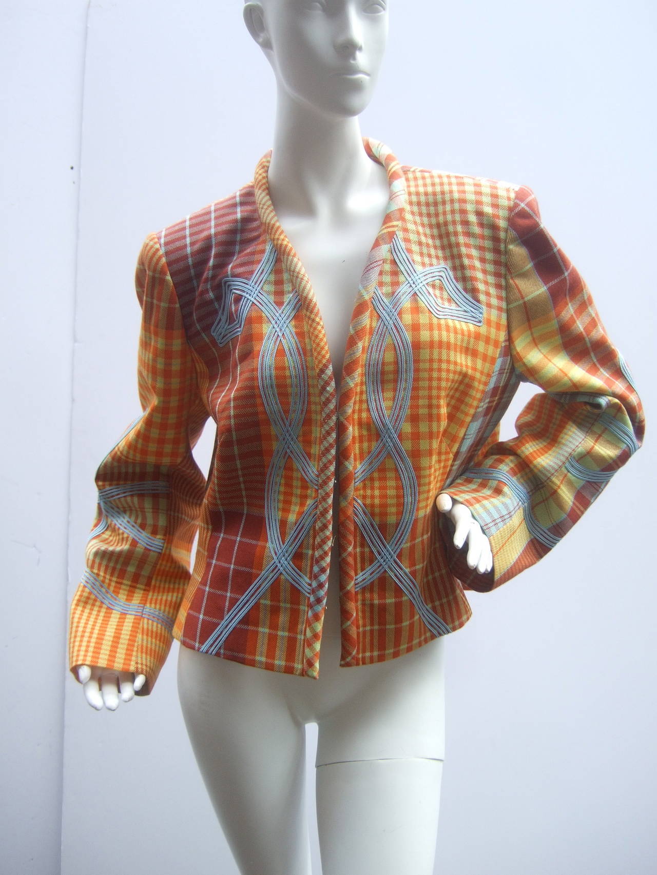 Christian Lacroix Paris Plaid wool jacket Size 46 c 1990s
The unique high fashion jacket is designed with bold
plaid colors; embellished with pale blue contrasting 
applique on the front exterior that extends to the sleeves 

The collar & front