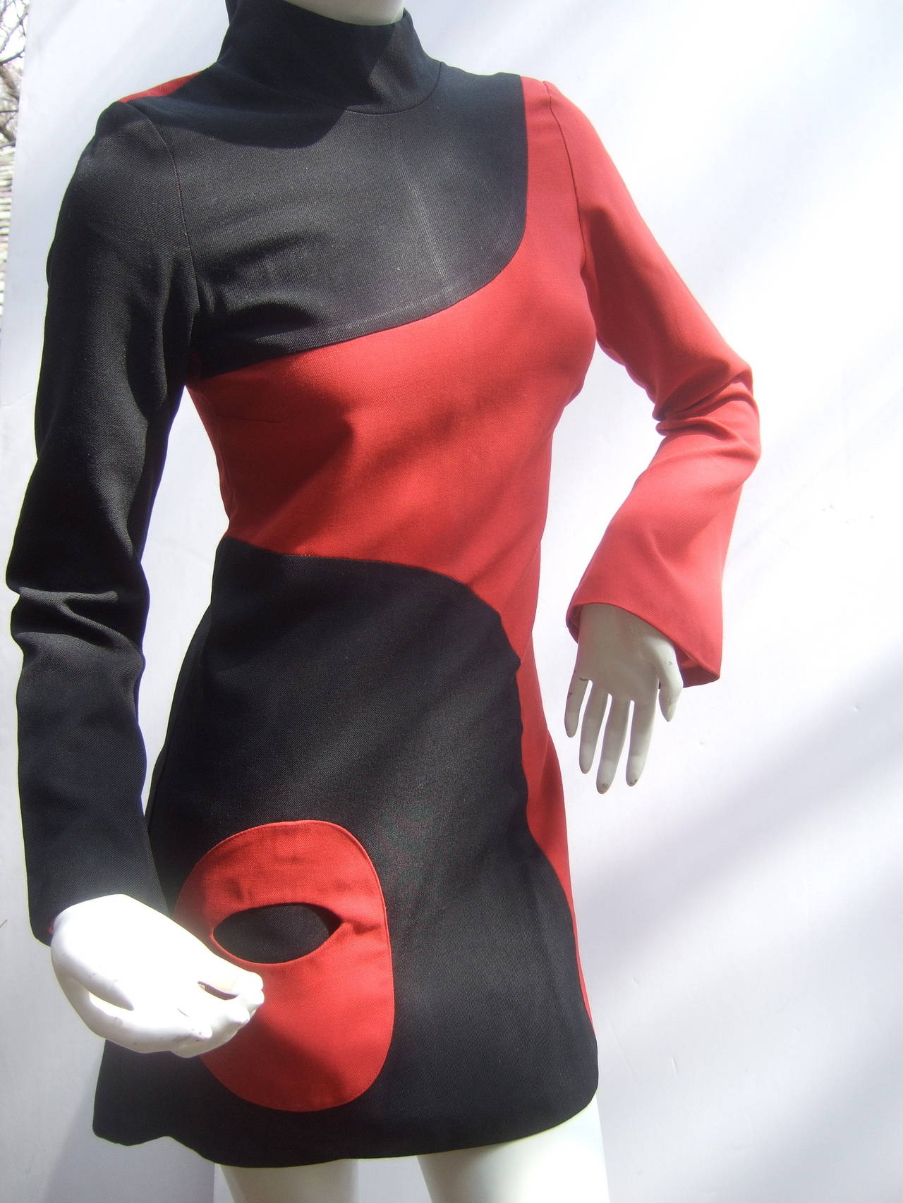 Mod wool tunic / mini dress designed by Marinelli Made in France c 1970
The retro space age design is color blocked with red & black wool panels 
The lower front section of the dress is designed with an oval shaped 
circular pocket

The