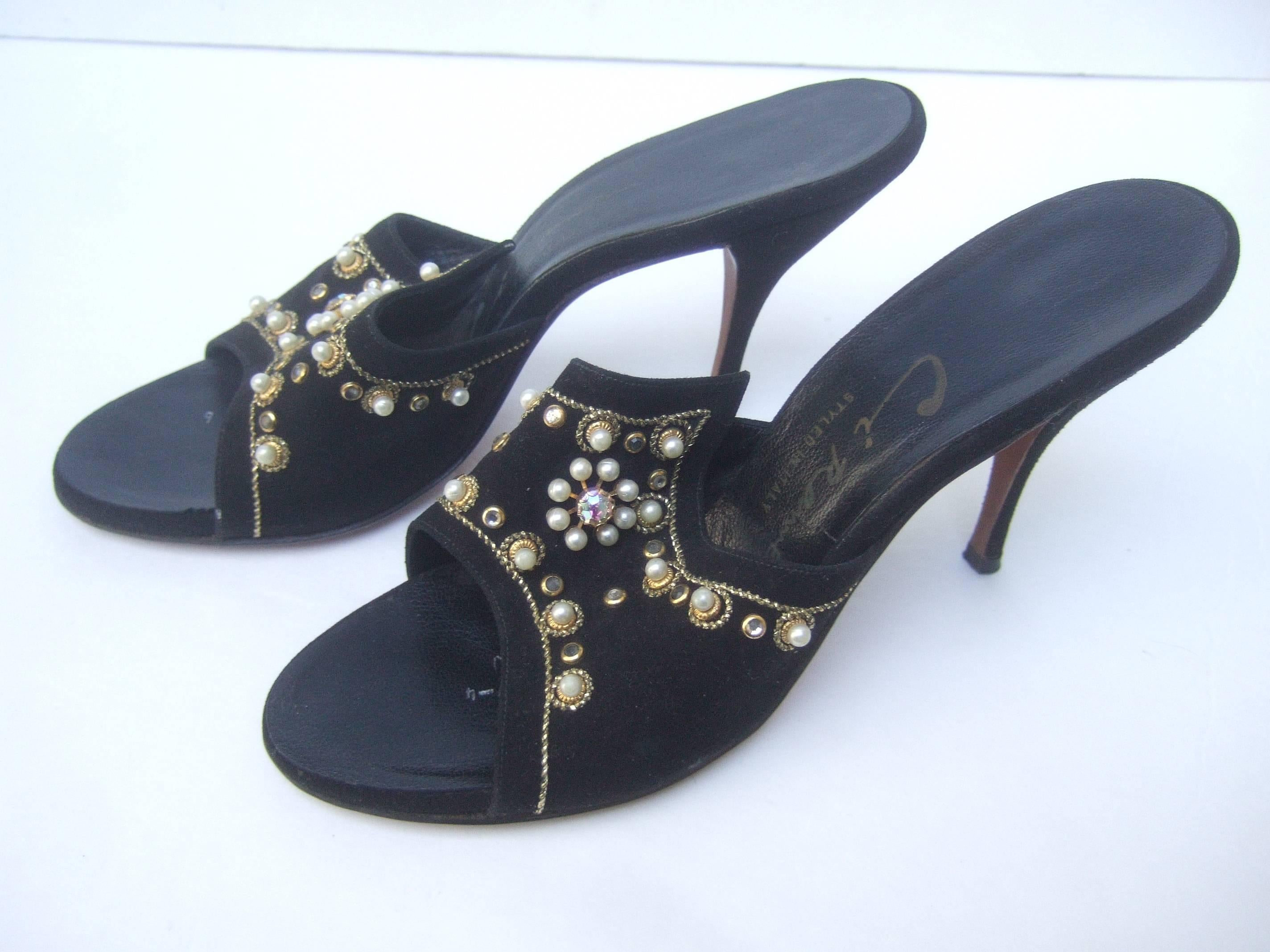 Jeweled vintage black suede mules Made in Italy
The chic retro pumps are embellished with
glittering crystals and clusters of resin enamel
pearls

The open toe heels are accented with gold 
metallic trim. The elegant retro shoes make
a very