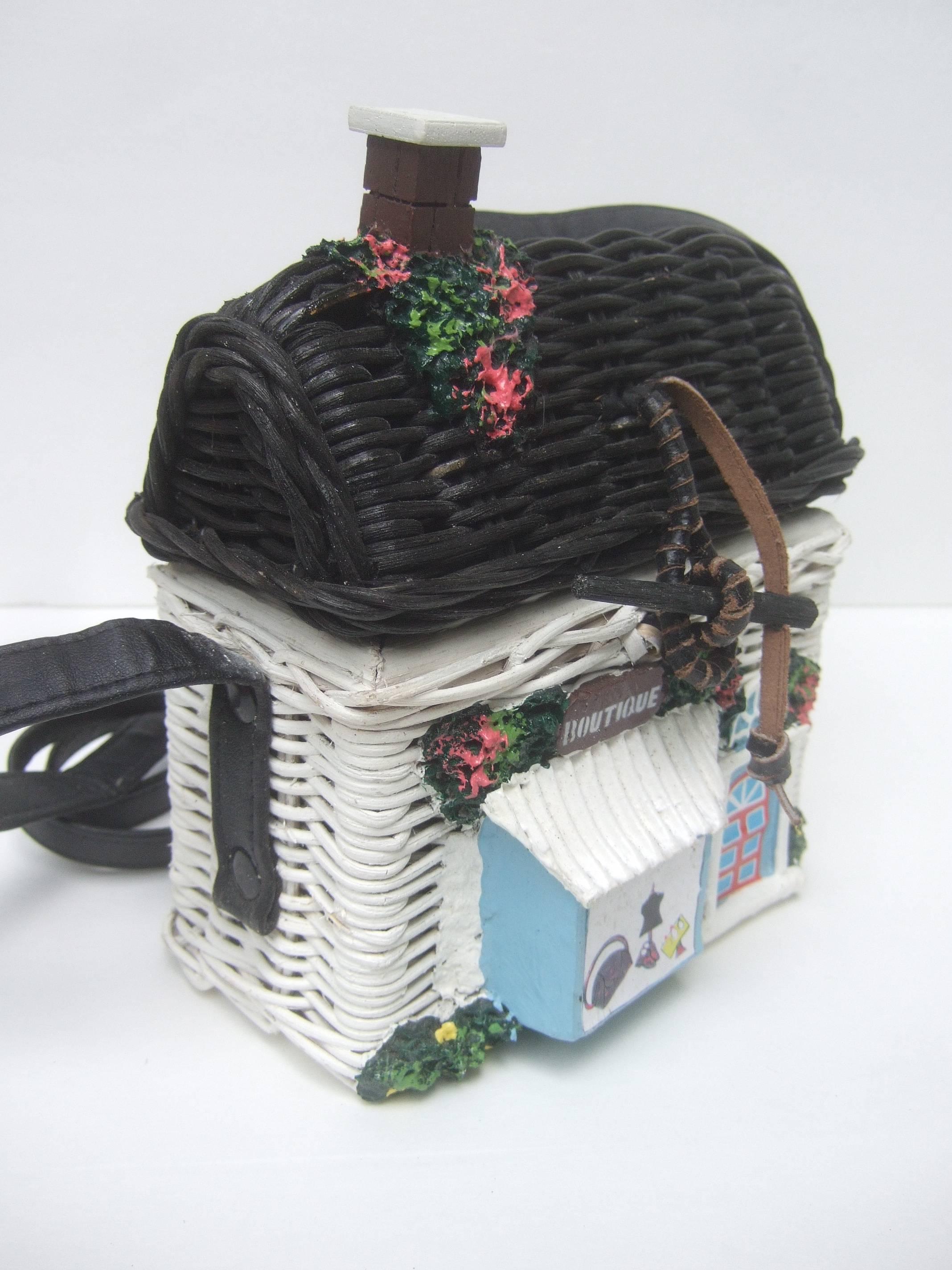 Timmy Wood's Charming wicker house shaped handbag
The whimsical wicker artisan handbag is designed as a 
women's retail clothing boutique shop

The front of the wicker house shoulder bag is designed
with a door and shop window featuring women's