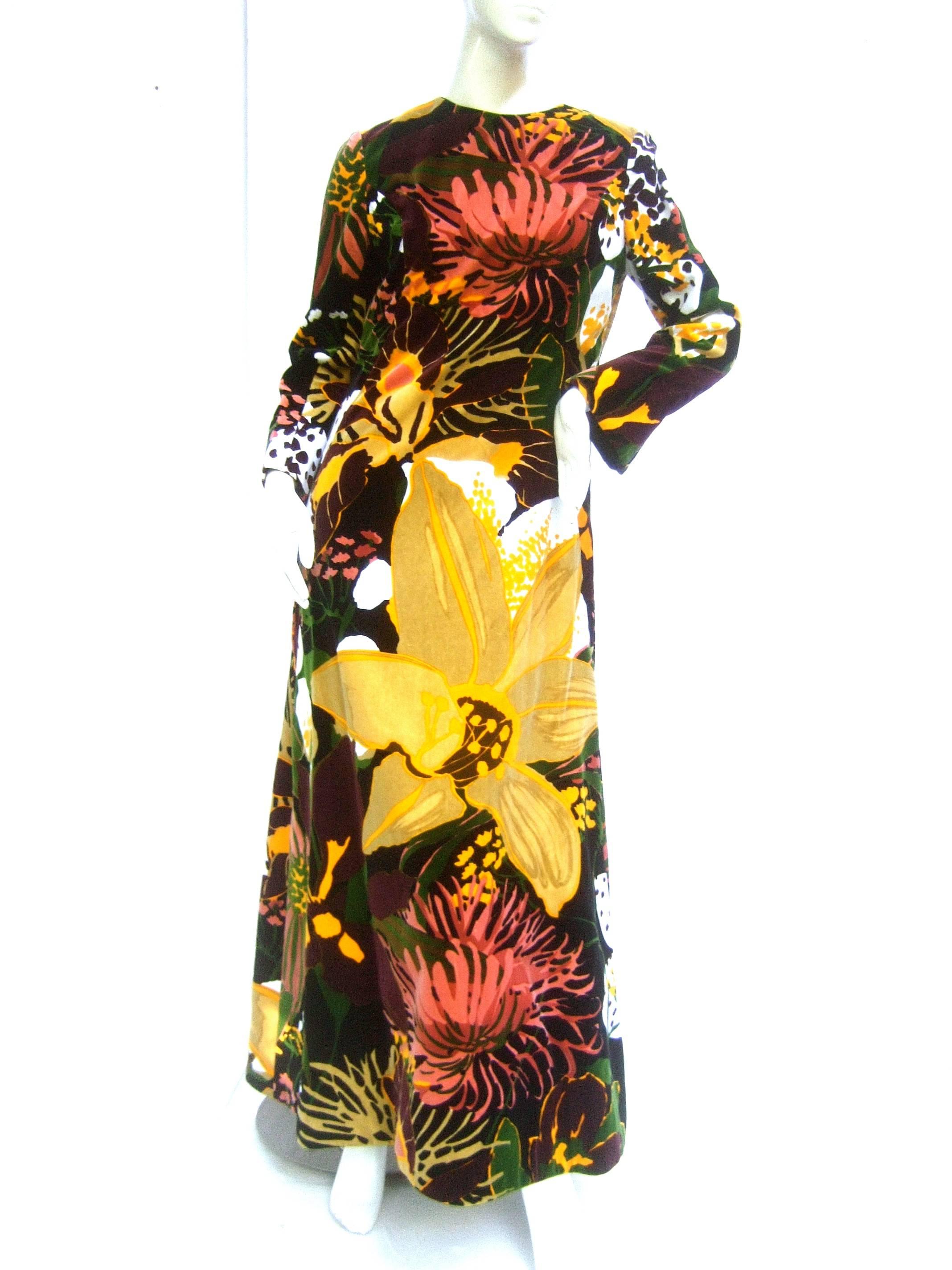 Bill Blass Stunning cotton velvet floral gown c 1970
The designer velvet gown is illustrated with 
bold flower blooms throughout

The vibrant flowers are illuminated against 
a black velvet background. The plush cotton 
velvet fabric is