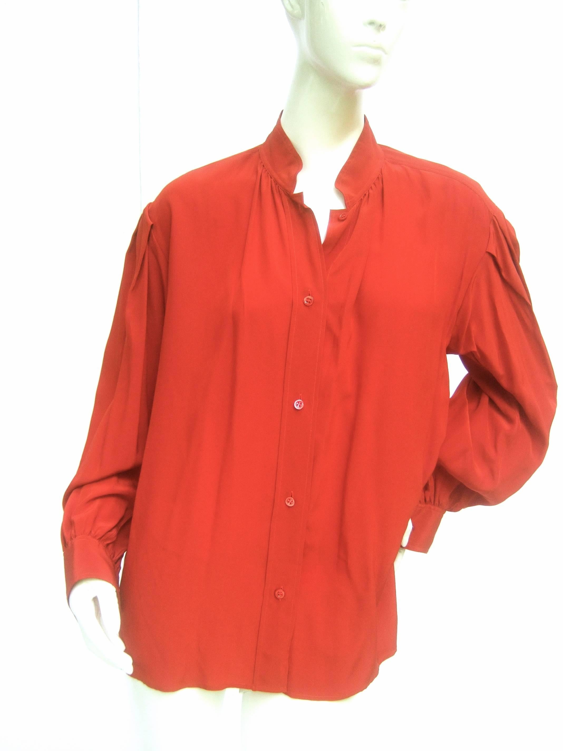 Saint Laurent Rive Gauche Crimson red silk blouse c 1970s
The elegant silk blouse is designed with reddish cooper
brown color

The luxurious silk drapes loose with subtle pleats at the 
neckline, shoulders and cuffs. The Nehru style  stand up