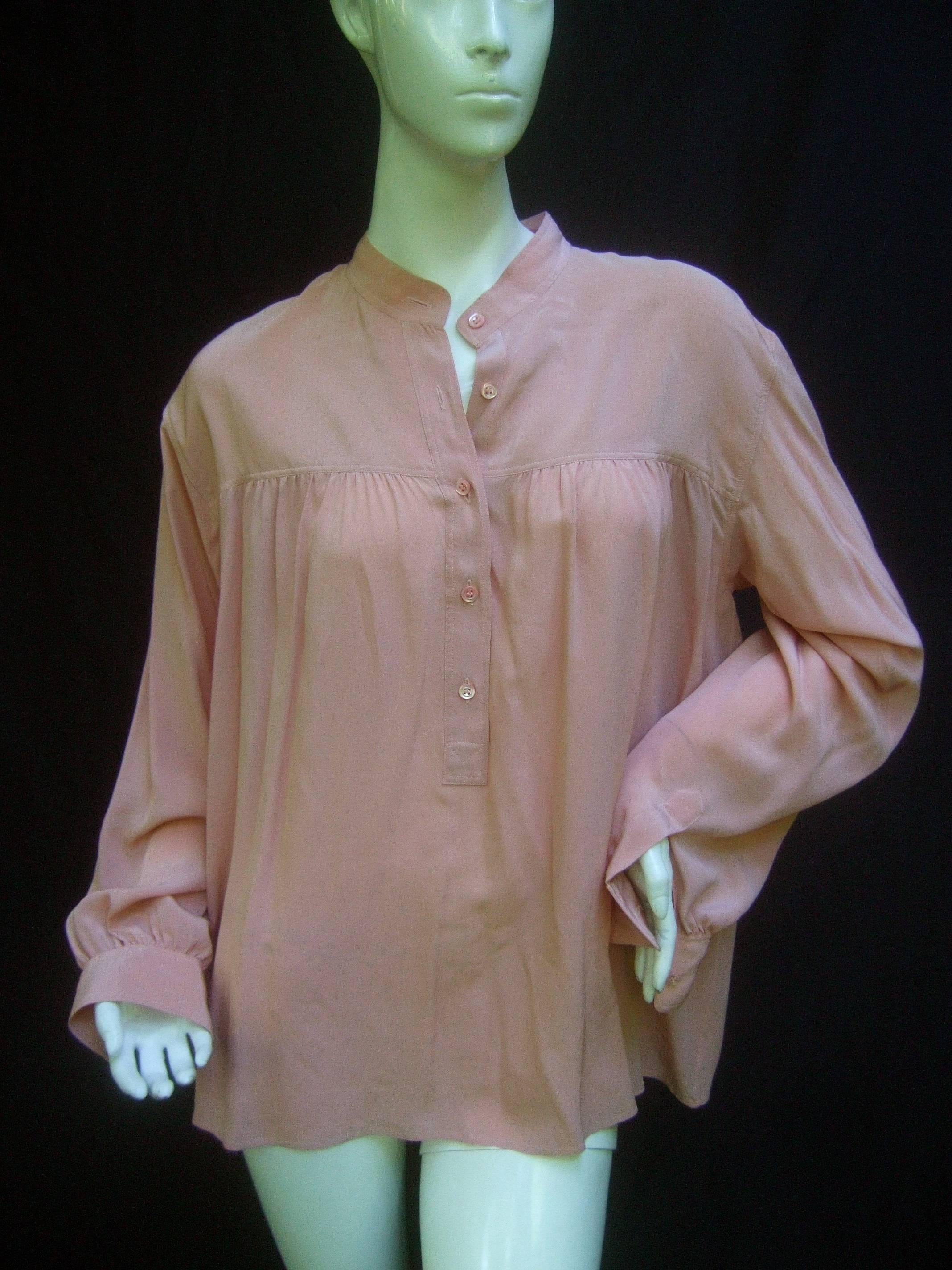 Saint Laurent Rive Gauche Mauve silk blouse ca 1970s 
The stylish YSL tunic style blouse is designed with luxurious 
pale pink silk

The Mandarin style collar is accented with a partial 
row of delicate pale pink buttons that run down the