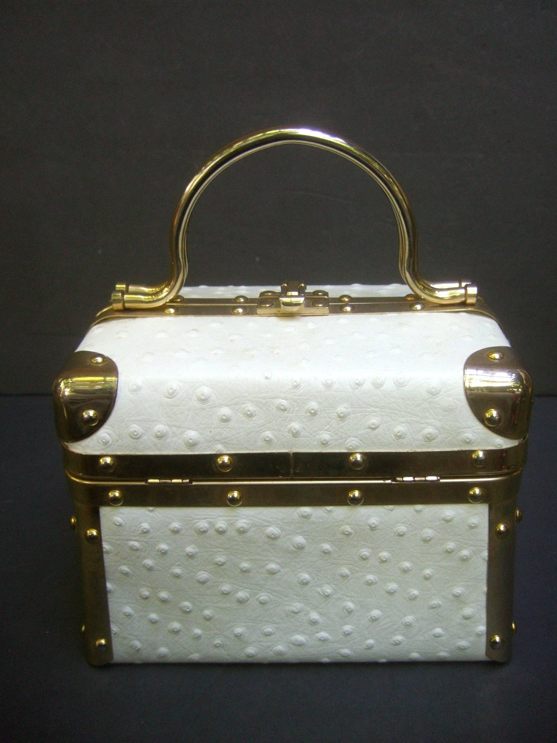 Borsa Bella Italian white ostrich leather box purse c 1980s
The posh Italian handbag is covered with exotic
white ostrich leather on all sides 

Designed with sleek gilt metal hardware trim with metal
swivel handles. The interior is lined in brown