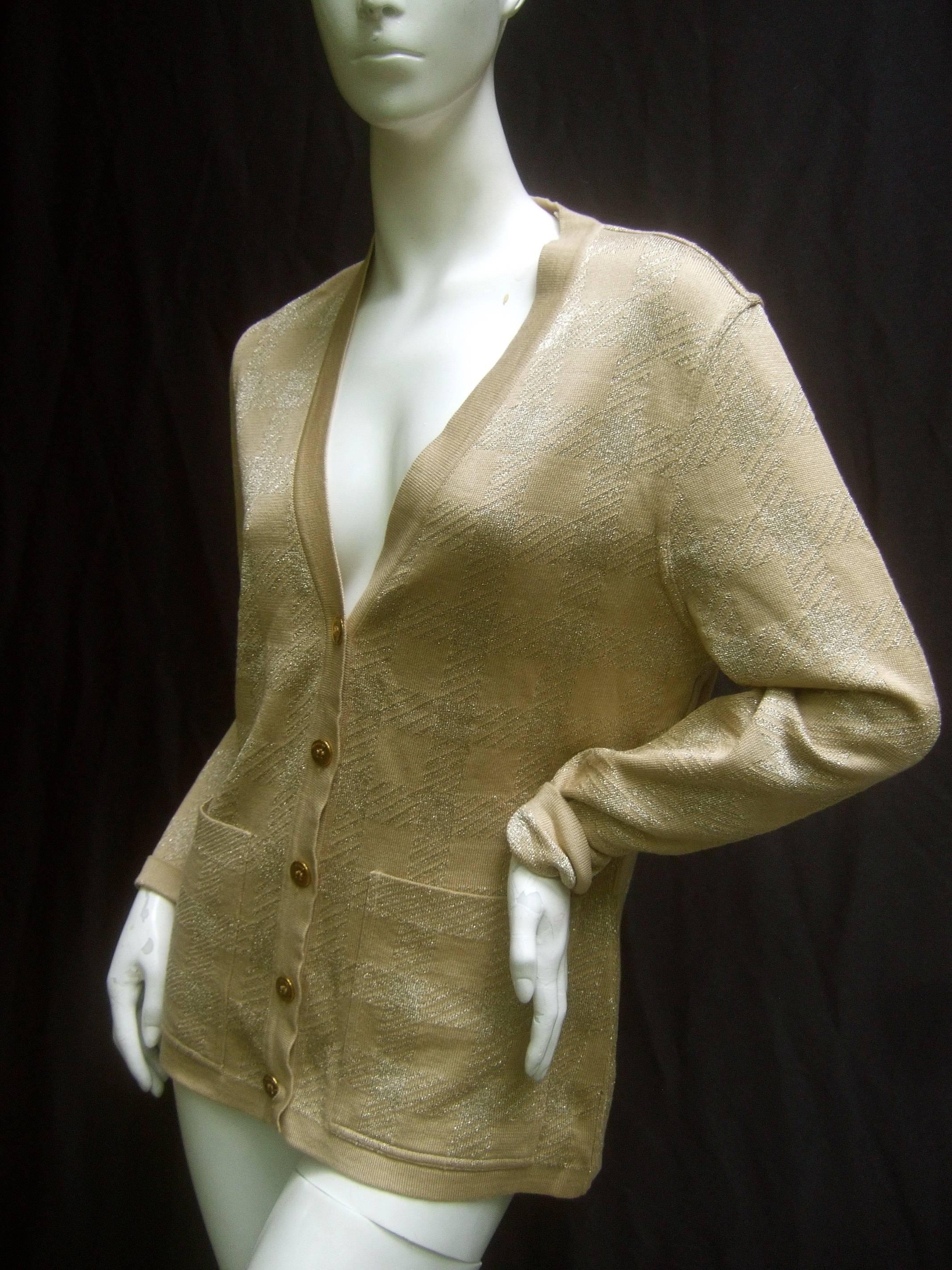 Celine Paris Gold metallic Italian knit cardigan Size 38
The stylish gold metallic knit cardigan is adorned 
with five gilt metal buttons each inscribed Celine 

The gold metallic knit fabric has a subtle checkered
design in two shades of gold