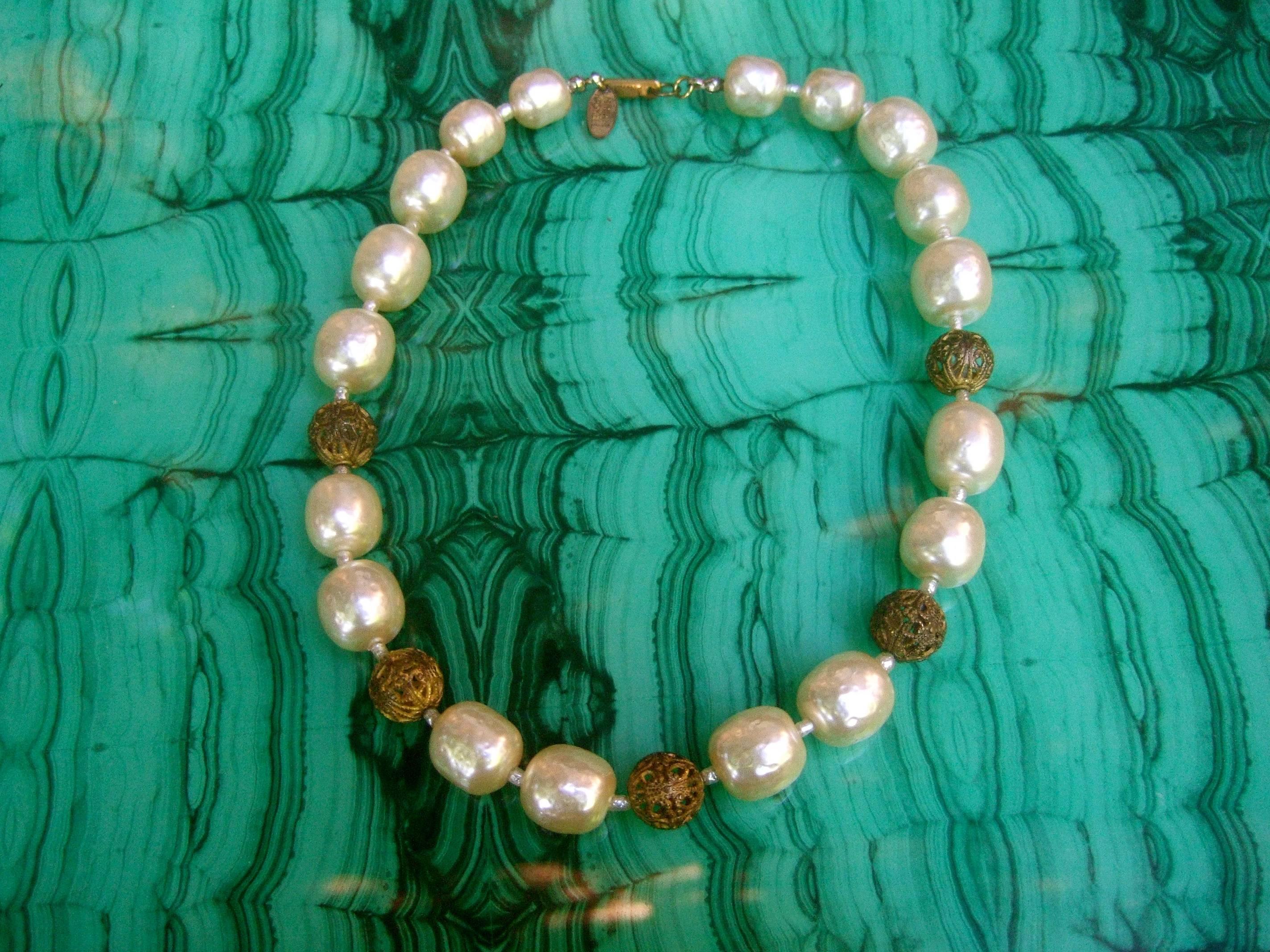Miriam Haskell Elegant baroque glass enamel pearl choker necklace
The designer costume necklace is designed with a strand
of lustrous baroque style almond shaped glass enamel pearls 

Interspersed within the glass pearls are smaller seed pearl