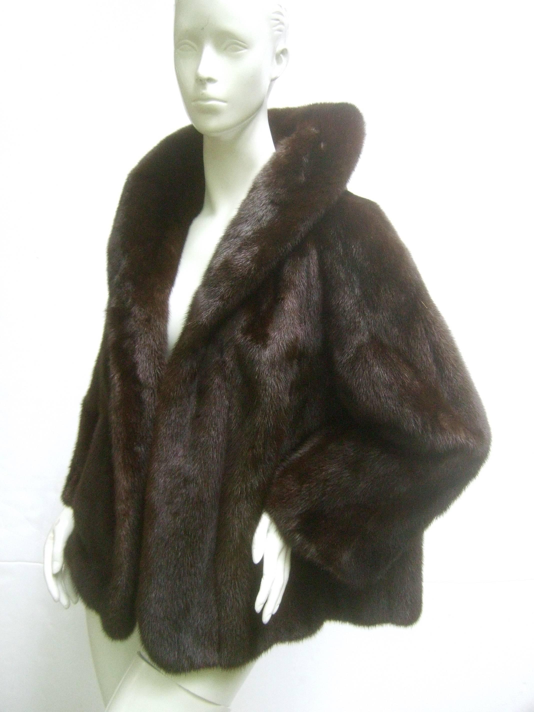 Revillon Paris sumptuous mahogany dark brown cropped jacket for Saks Fifth Avenue  c 1970s 

The luxurious mink jacket is designed with plush dark brown fur
The wide soft mink fur collar can be wrapped around the neck

The elegant ranch mink jacket