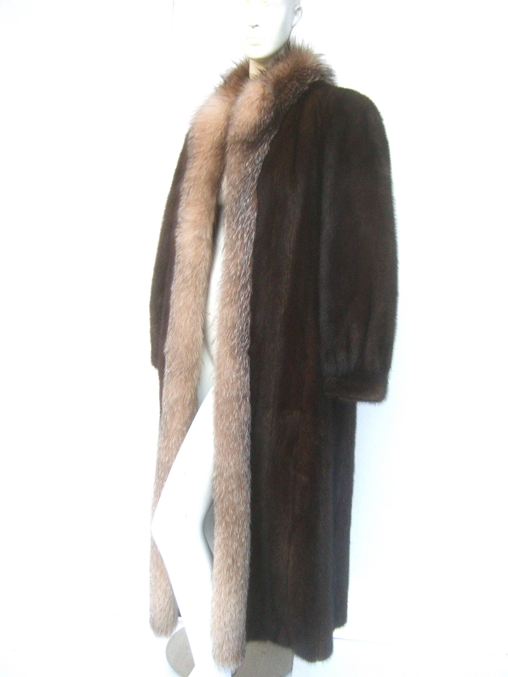 Luxurious mahogany brown mink fox collar coat for Neiman Marcus c 1980s
The stylish coat is designed with plush dark brown mink fur
The collar is framed with a plush fox fur band that circles 
the neckline and runs down the center 

Lined in