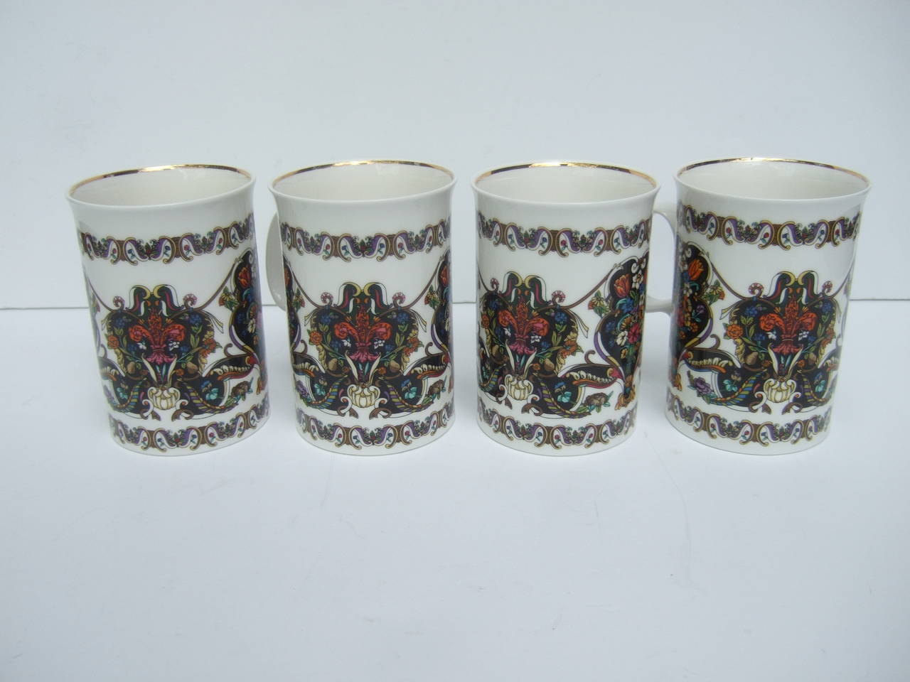 Gucci Rare set of four porcelain cups. Made in England c 1990
The porcelain cups are decorated with elaborate flower bouquet
decal stenciling. The floral design is replicated on all four of the 
porcelain cups

On each porcelain cup Gucci's