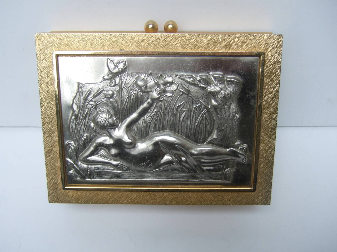 Exquisite gilt metal evening bag designed by Harry Rosenfeld c 1970
The lavish evening bag is embellished with an Art Nouveau 
style nymph lounging in a lush garden paradise

The opulent evening bag is designed with a pewter tone metal