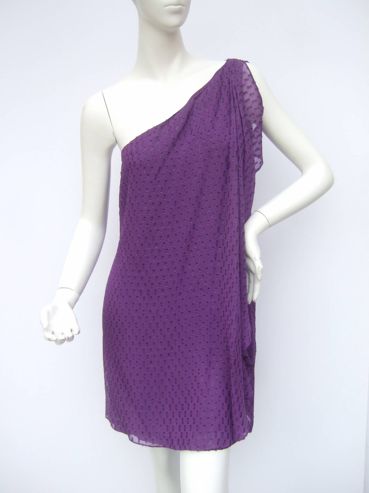 Halston Heritage violet silk one shoulder dress. New with tags US Size 8
The breezy sheer dress is designed with violet silk fabric with a geometric jacquard pattern. One side of the dress is designed with a sheer ruffled tiered overdraped panel