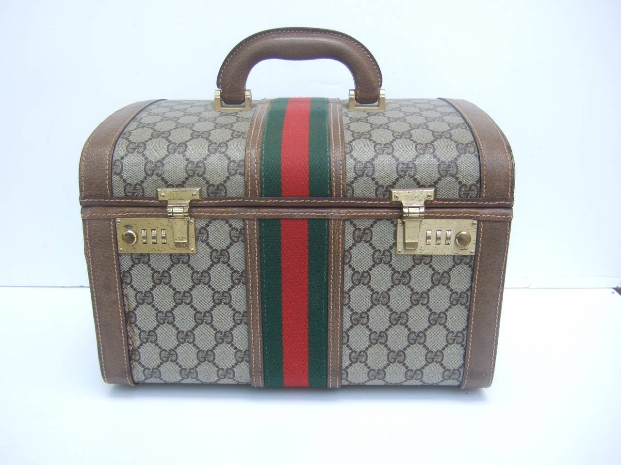 ***RESERVED SALE PENDING FOR CARMEL DANIELS***

Gucci Luxurious retro travel train case. Made in Italy c 1970s
The Italian vanity travel case is designed with Gucci's  
monogrammed logo covering with brown leather trim

The center of the
