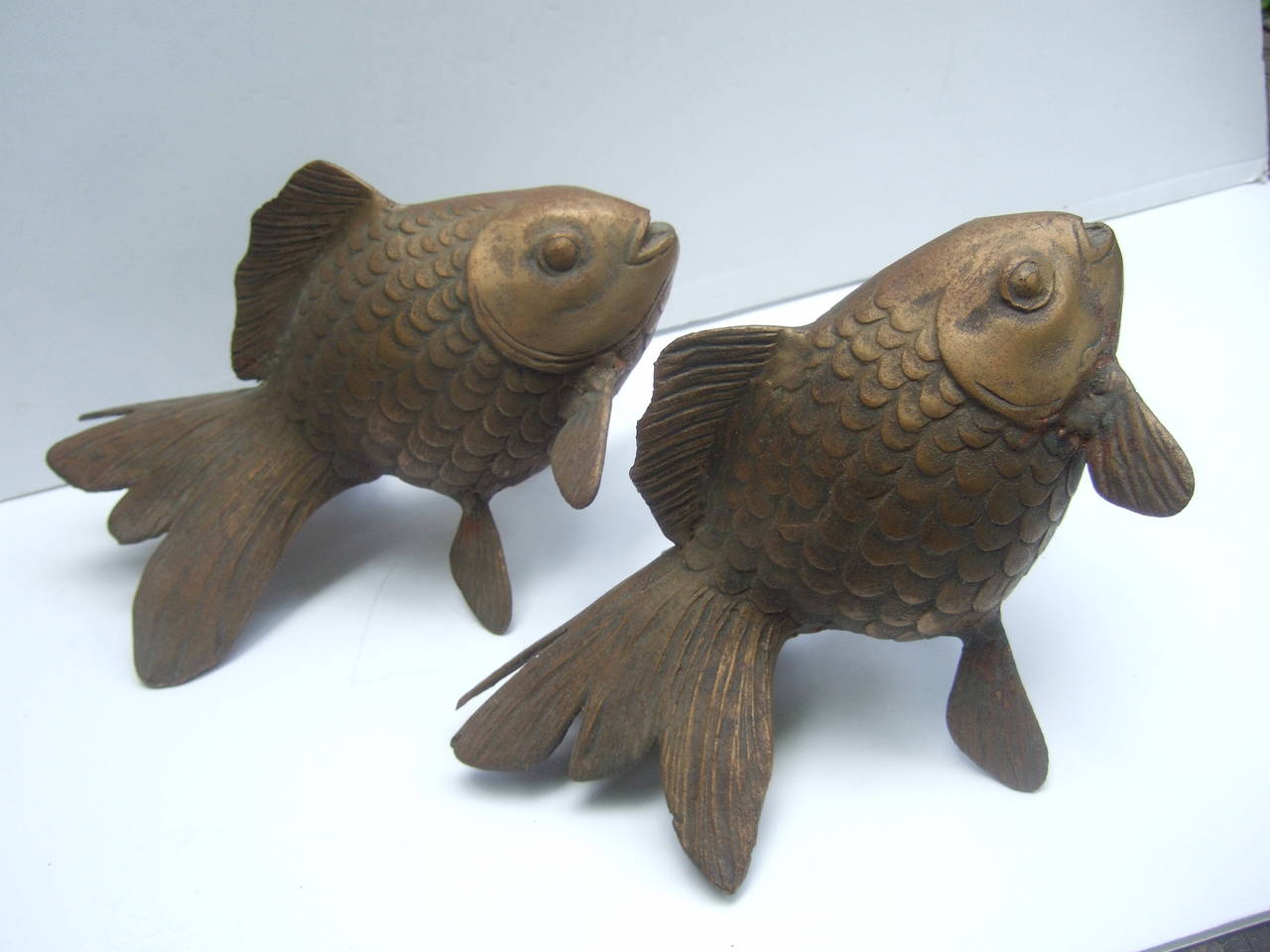 Paire de statues décoratives poissons koi en métal laiton doré Made in Japan c 1960
La paire stylisée de poissons koi en métal doré est conçue avec des
écailles et nageoires rainurées spectaculaires

La paire de poissons koi est conçue en tailles