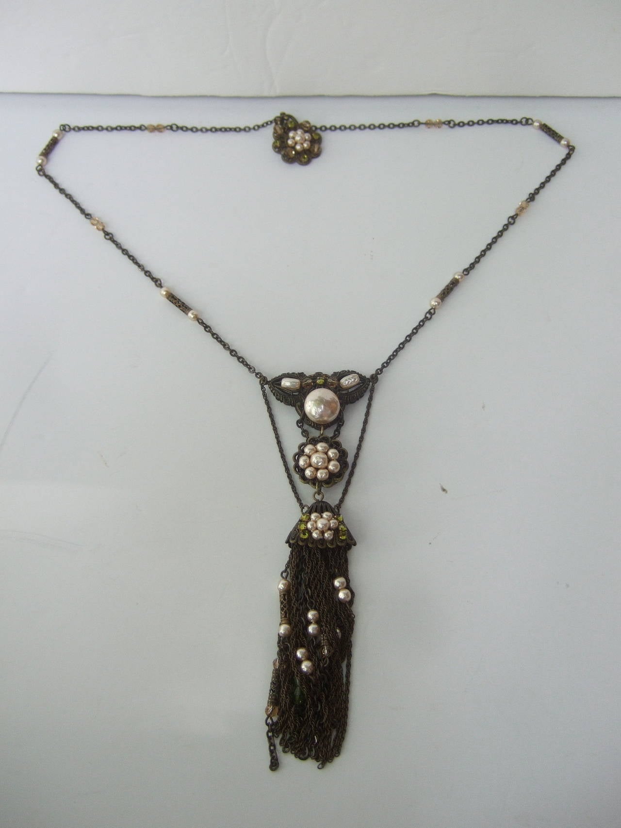 Exquisite Miriam Haskell Glass pearl sautoir chain necklace c 1940
The elegant dramatic necklace is embellished with baroque
enamel glass pearls & restrained crystals

The center tiered pendant is encrusted with clusters of lustrous