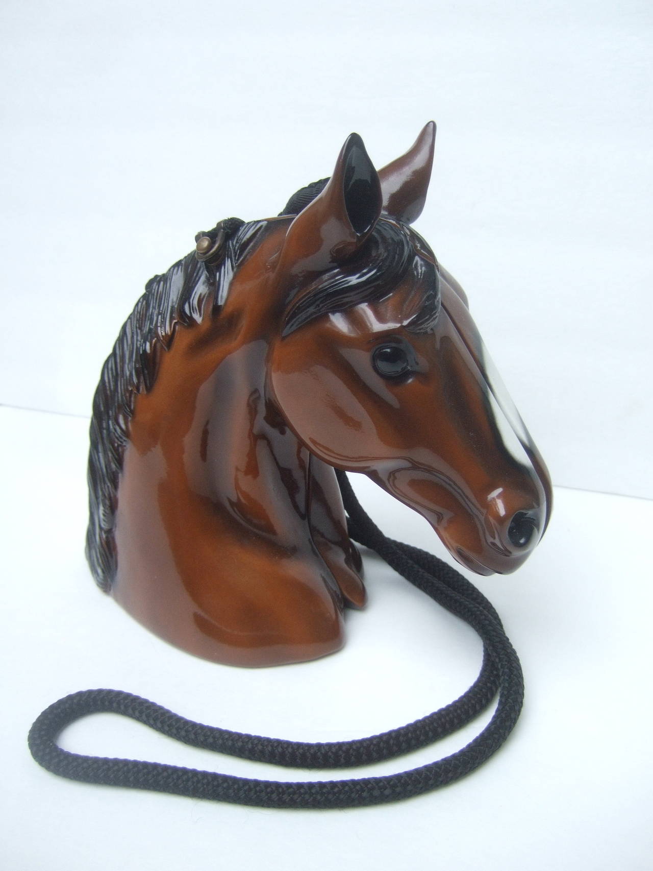 Timmy Woods Beverly Hills Horse head artisan handbag
The unique wood handbag is designed from fallen acacia trees
in the Philippines. The equine theme handbag is covered with
glossy brown, black & white enamel  

The rare horse head shoulder
