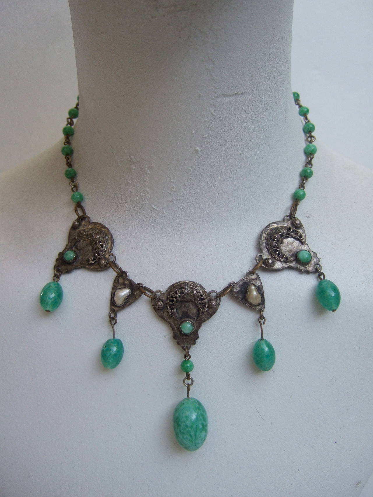 1930s Art Nouveau Peking glass tear drop choker necklace 
The exquisite necklace is designed with oval shaped milky
green glass dangling stones

The elegant necklace is designed with two small glass
enamel baroque pearls. The dangling glass