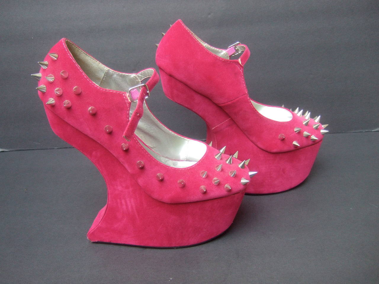Avant-garde fuchsia velvet spike platform shoes US Size 9 
The edgy sky high platforms shoes are designed with
chrome metal industrial spikes on the front & outer sides

The show stopping ankle strap platforms make a very dramatic 
jaw dropping