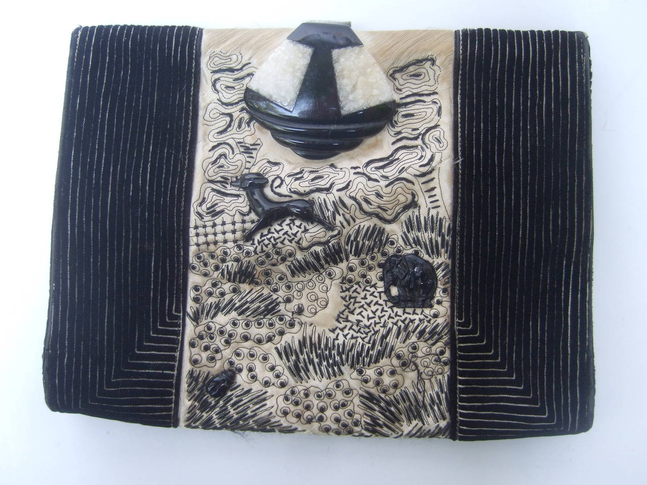 1920s Art Deco Exquisite silk embroidered clutch 
The elegant clutch is adorned with a black & white
celluloid clasp. The center panel is ivory embroidered
silk with a collection of exotic resin creates;
elephants, gazelles & a few small beetles