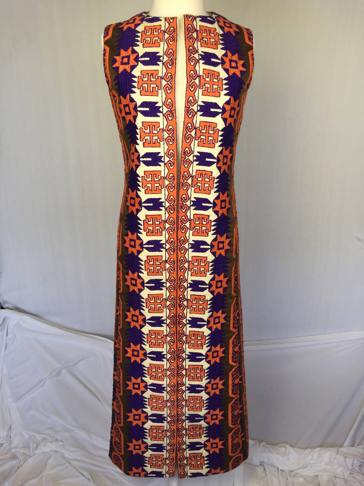 Early 1970's Calvin Klein maxi vest made of heavy, stiff, brown cotton/silk faille and off white canvas embellished all over with an amazing abstract design of orange and purple embroideries inspired by early Native American textiles.  There is