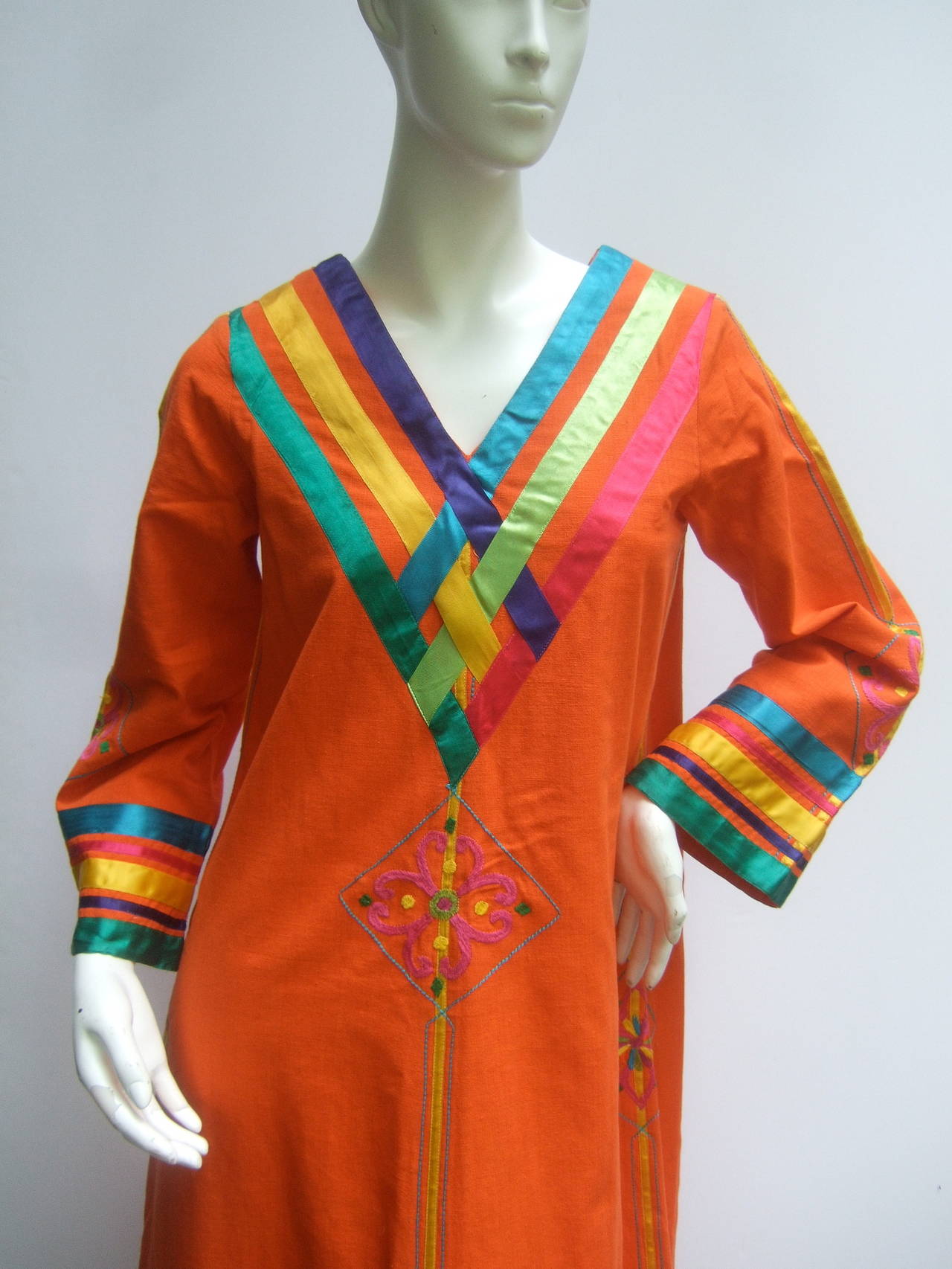 Vibrant Mexican festival tangerine cotton caftan designed by Josefa 
The exotic cotton caftan is embellished with wide colorful satin 
ribbons that frame the v-neck collar, sleeves & circle the hem

The sturdy orange cotton fabric is accented